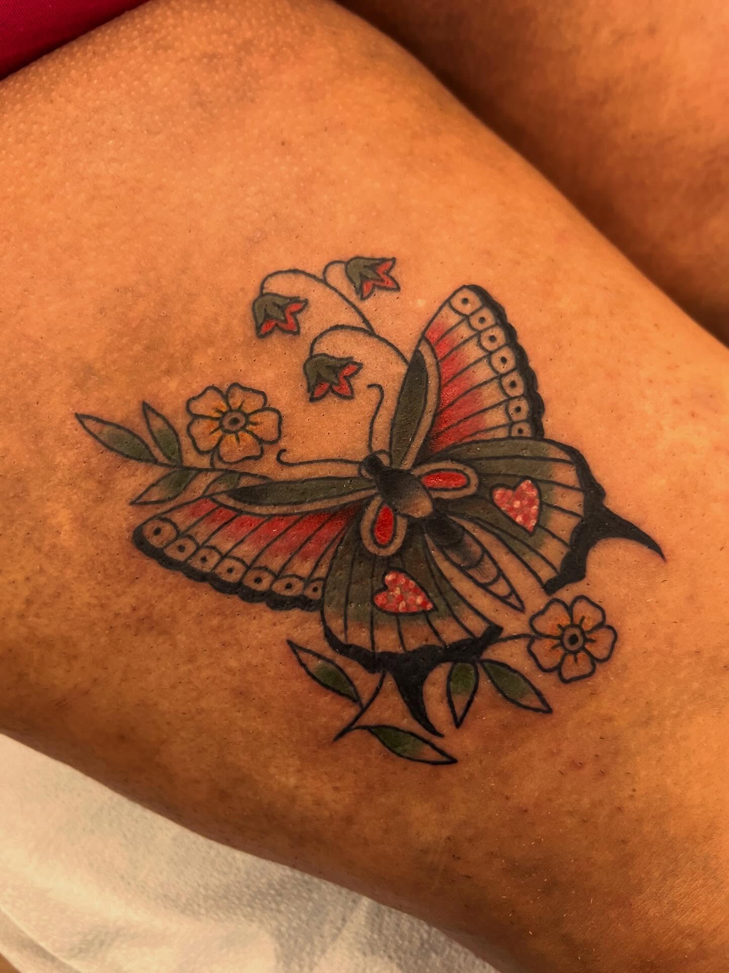 Butterfly and flowers American traditional tattoo on the forearm by Samantha Citer
