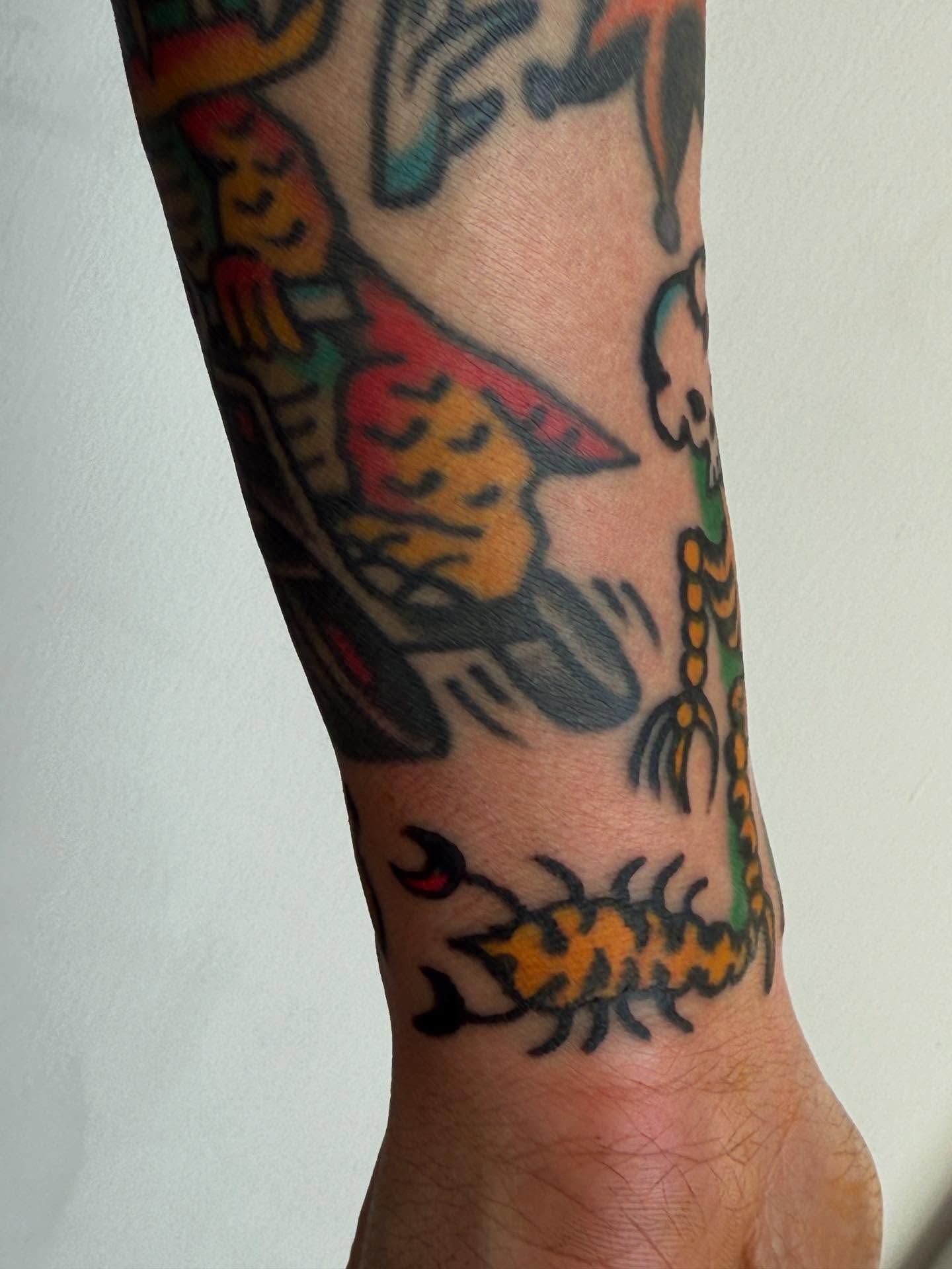Bird and scorpion American traditional tattoo on the forearm by JAX