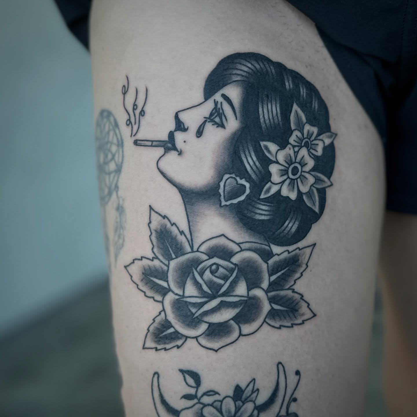 Smoking woman with flowers American traditional tattoo on the thigh by Walk-in American Traditional Tattoos Las