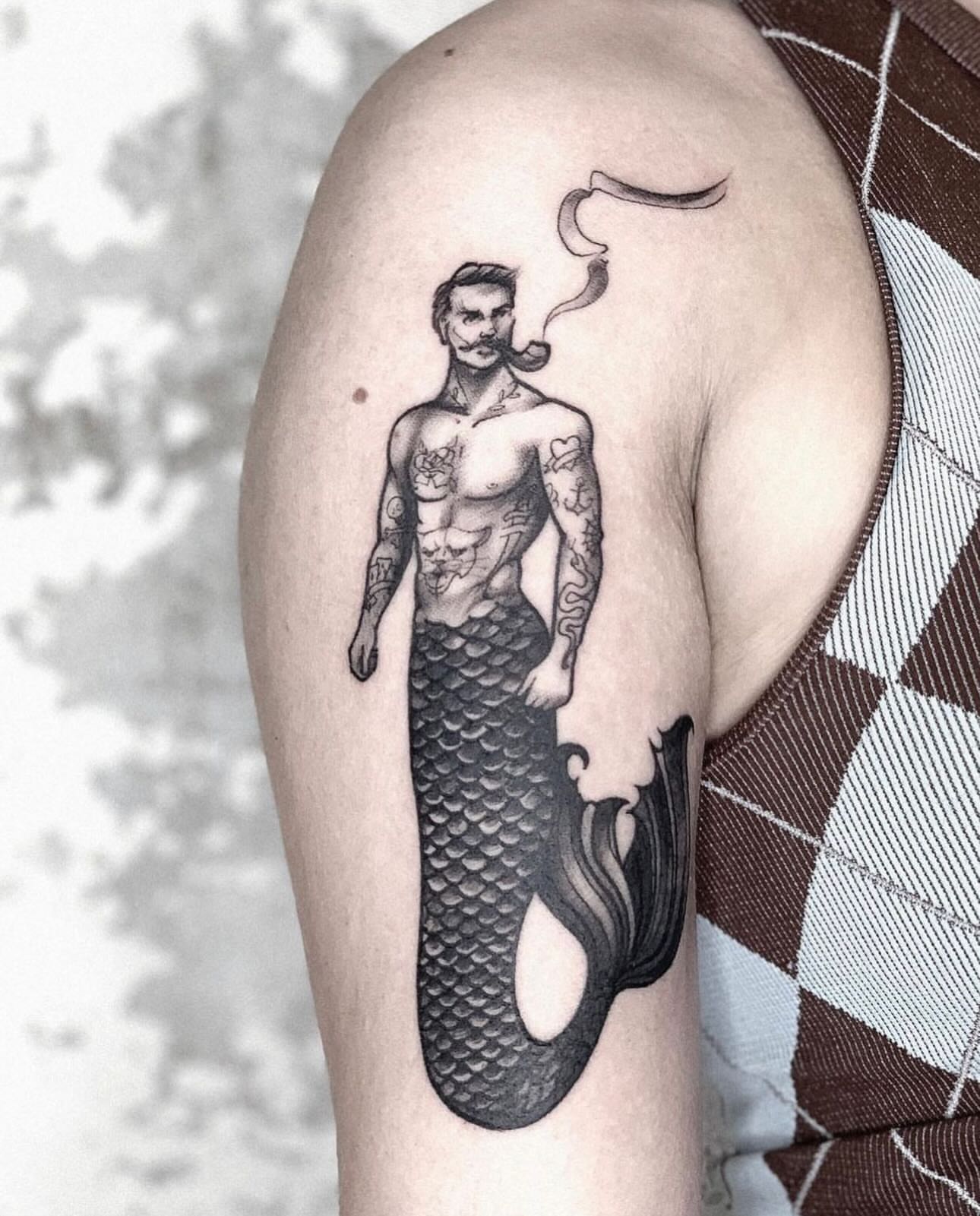Merman black and grey tattoo on the upper arm by Elvira Savchuk