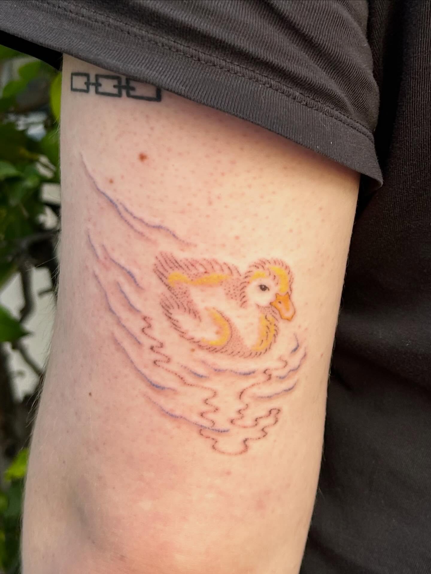 Flying duck new school tattoo on the forearm by Nicolette