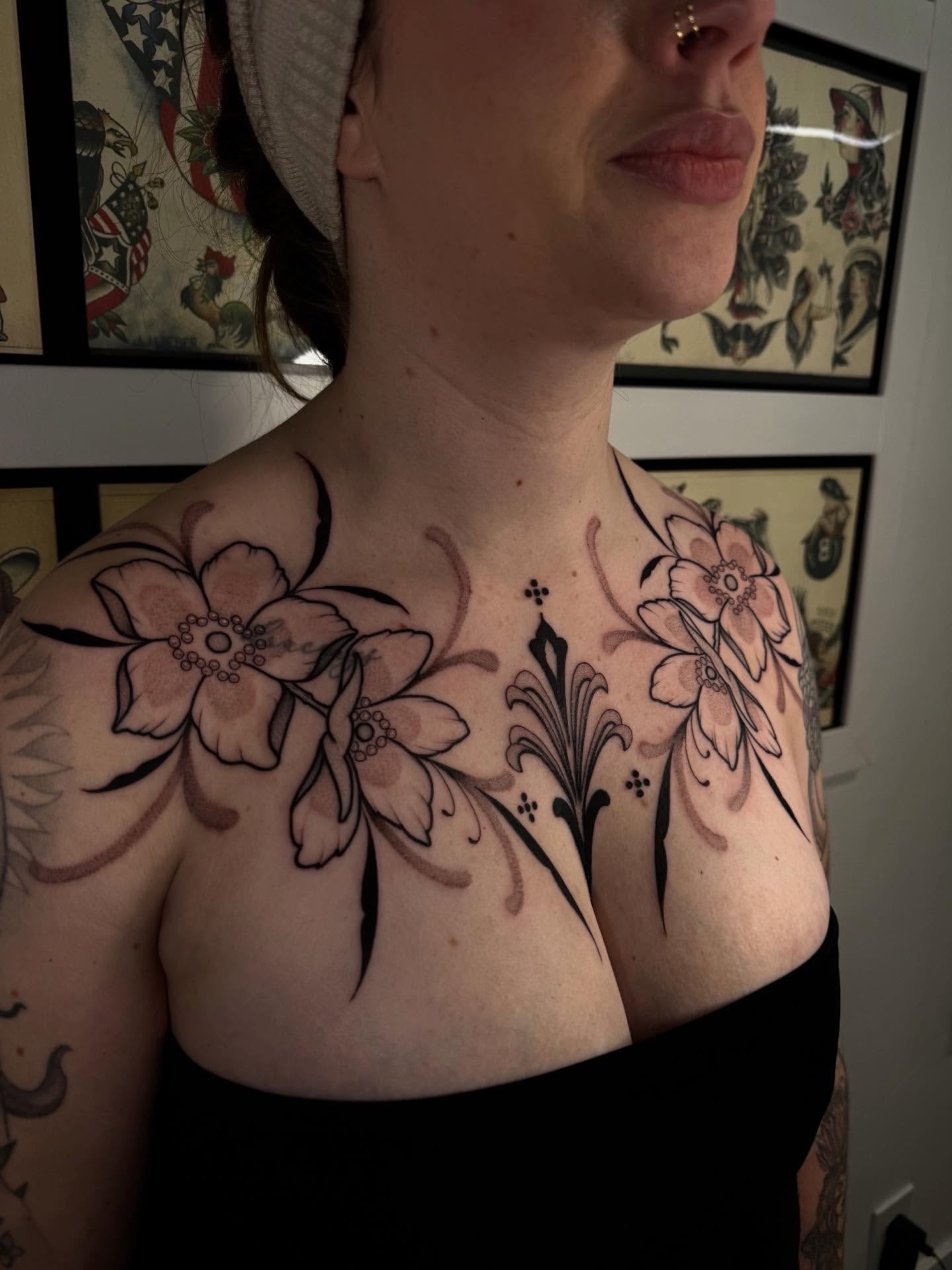Floral black and grey tattoo on the chest by Erin Shea