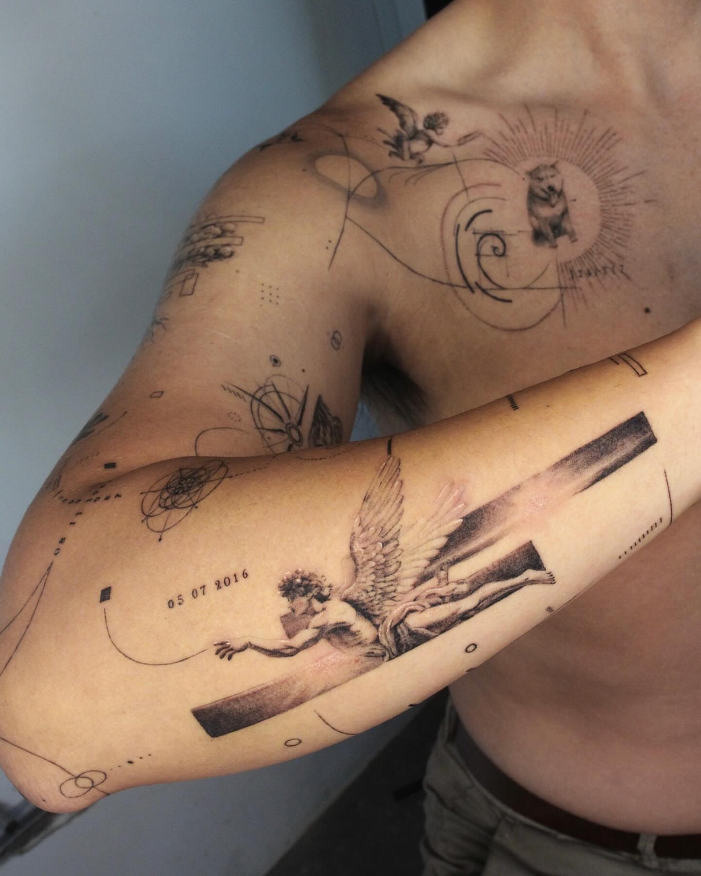 Angel with book realism tattoo on the forearm by Tattoo artist EJ (Mireu)