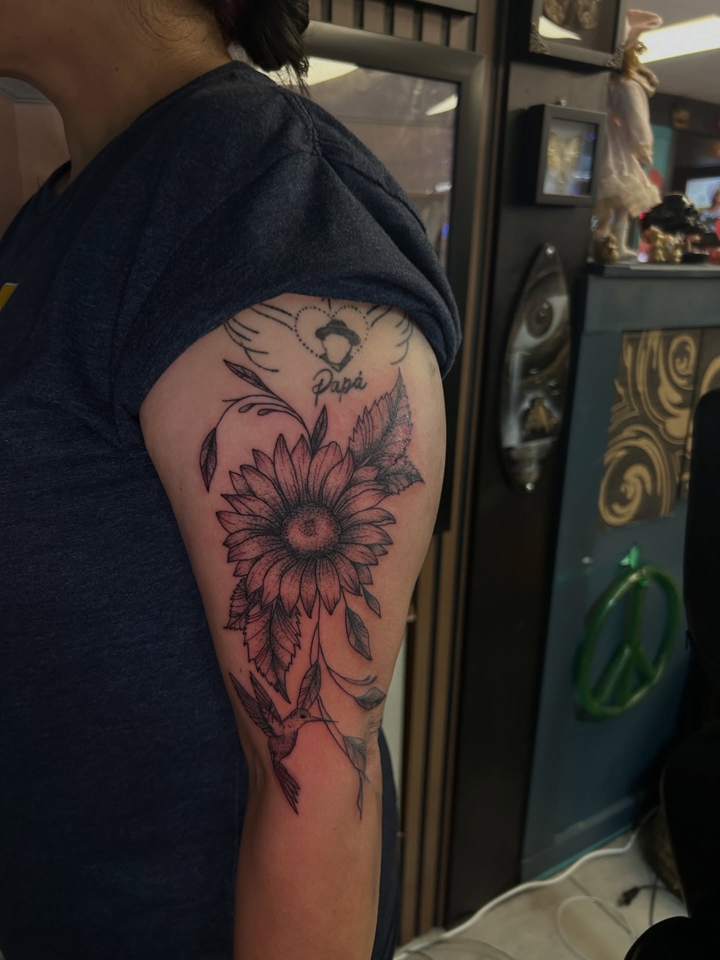 Sunflower black and grey tattoo on the upper arm by Torrey, Austin, Texas
