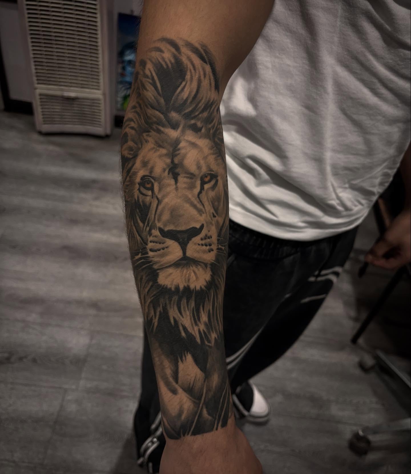 Lion realism tattoo on the forearm by michael
