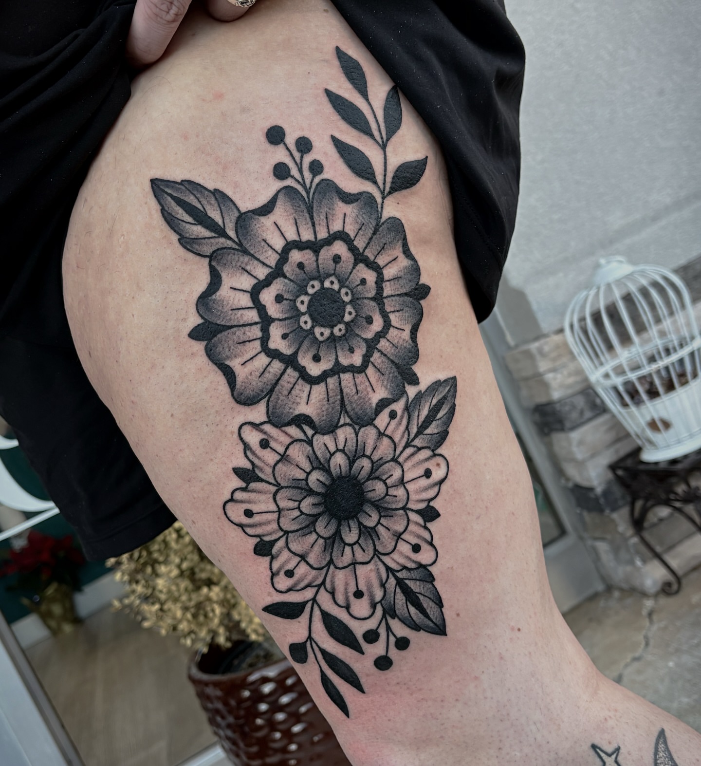 Floral arrangement black and grey tattoo on the thigh by Bunny Noel