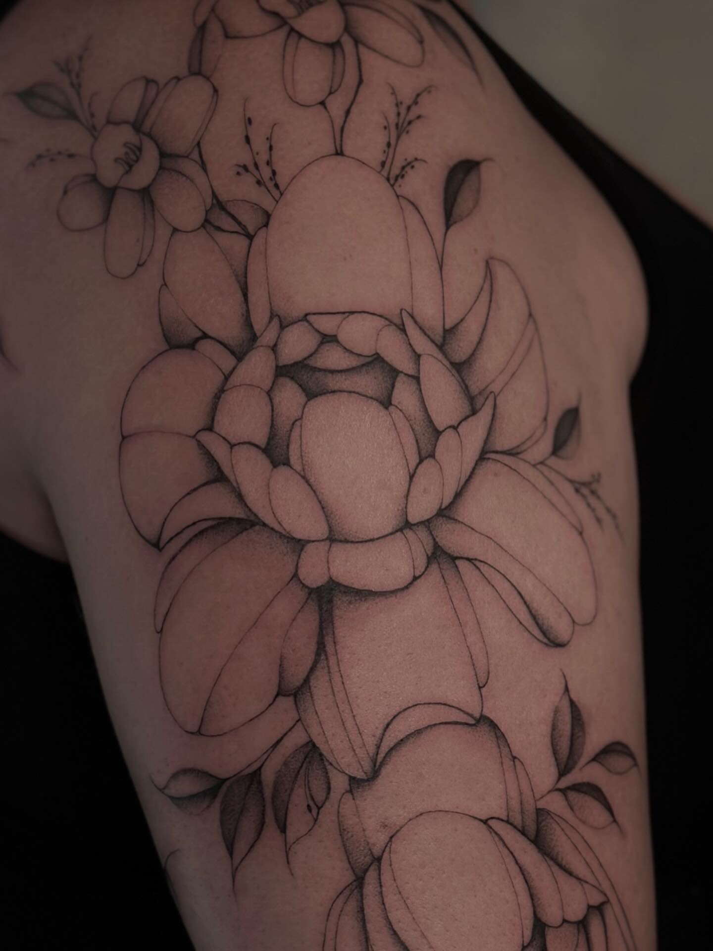 Lotus flower black and grey tattoo on the upper arm by ꕥ LANA MOON TATU ꕥ