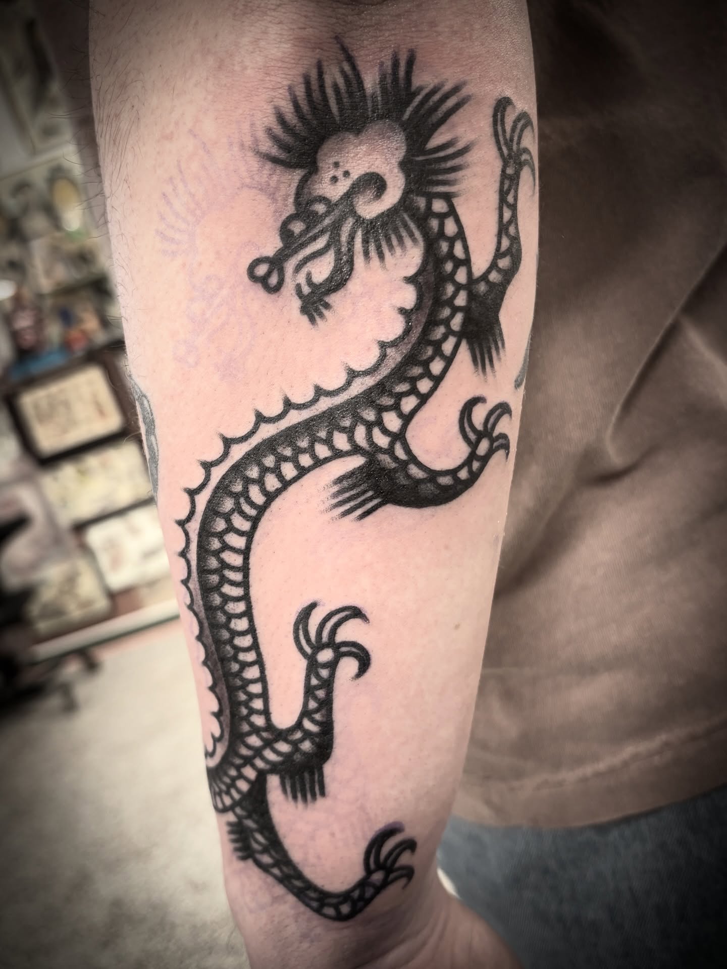 Dragon black and grey tattoo on the forearm by Deya Aven, Nashville, Tennessee