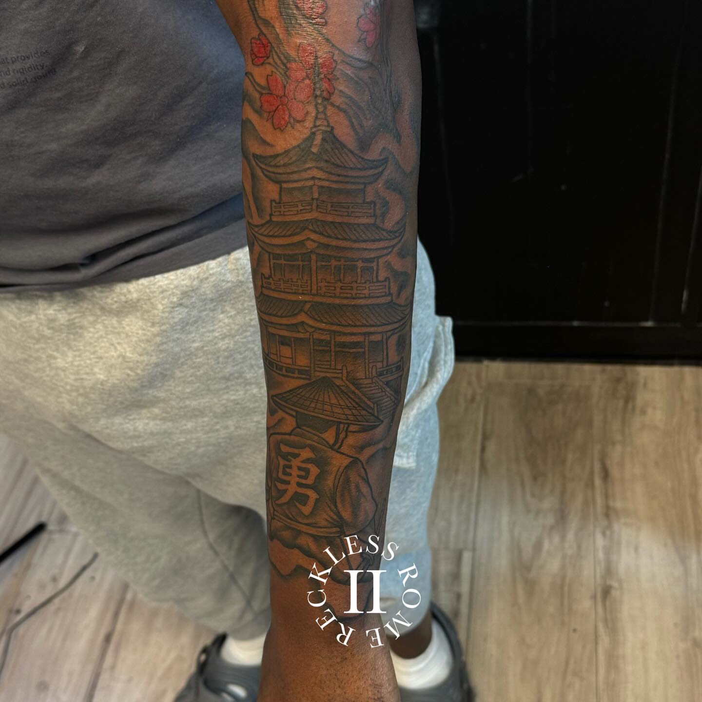 Cherry blossoms and pagoda japanese irezumi tattoo on the forearm by Rome