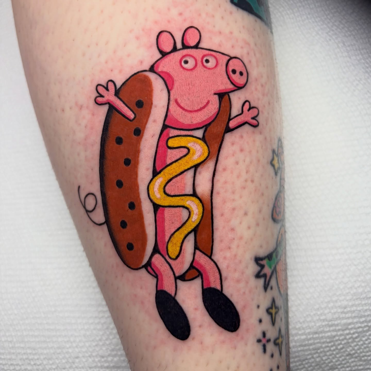 Peppa Pig hot dog illustrative tattoo on the forearm by Alena McDonald