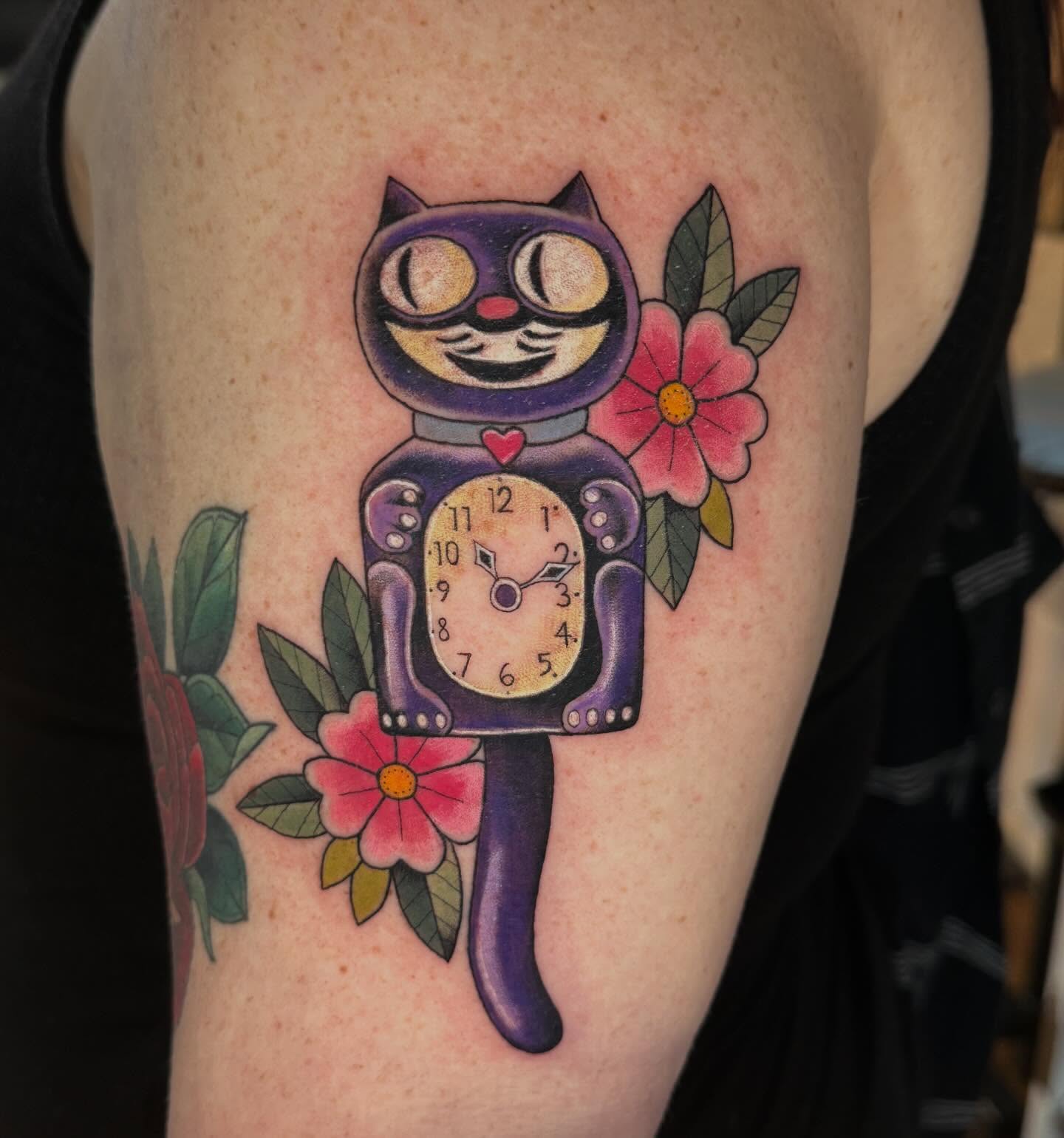 Cat clock American traditional tattoo on the forearm by Katy Bisby