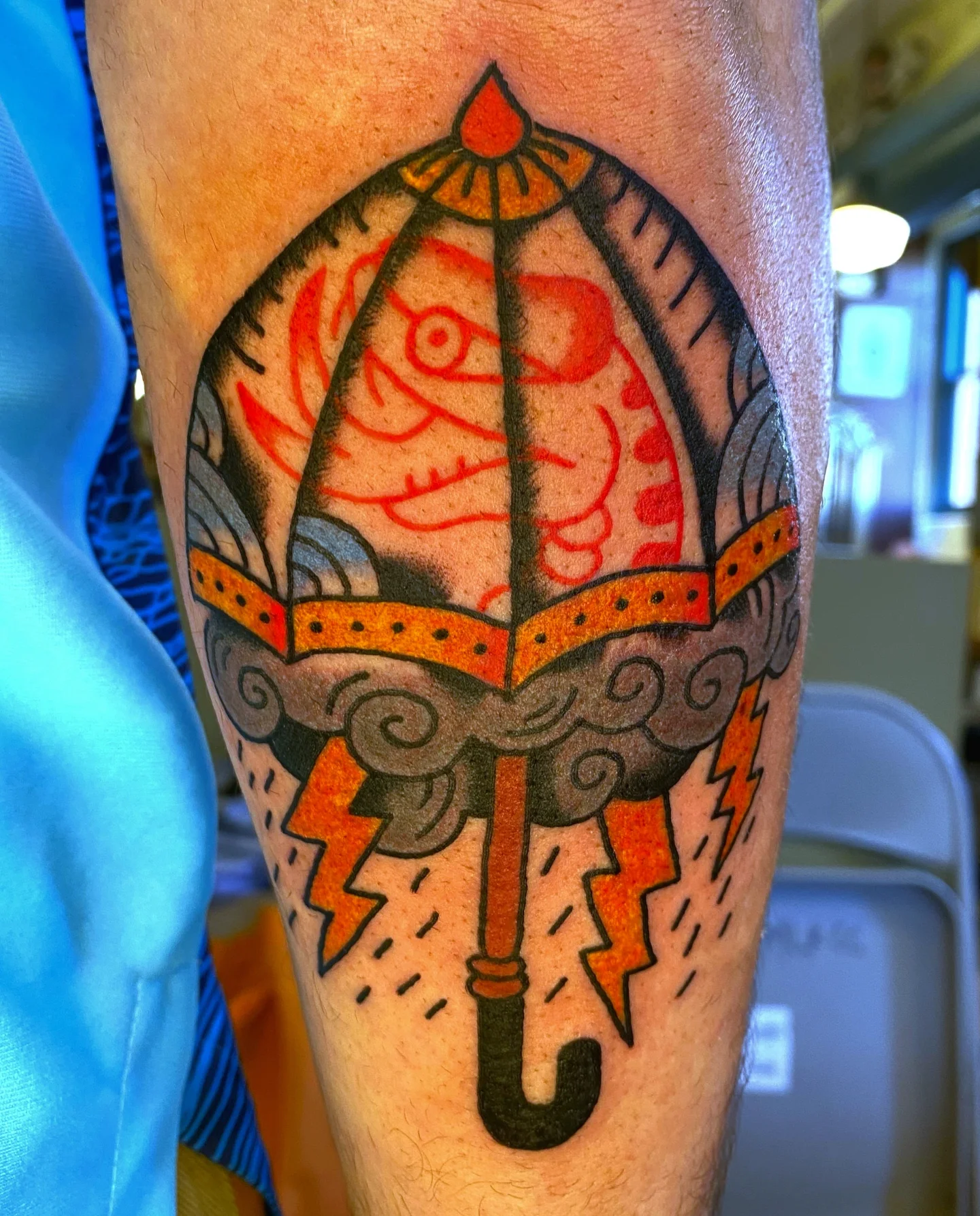 Umbrella and fish American traditional tattoo on the forearm by Quinn, Kansas City, Missouri