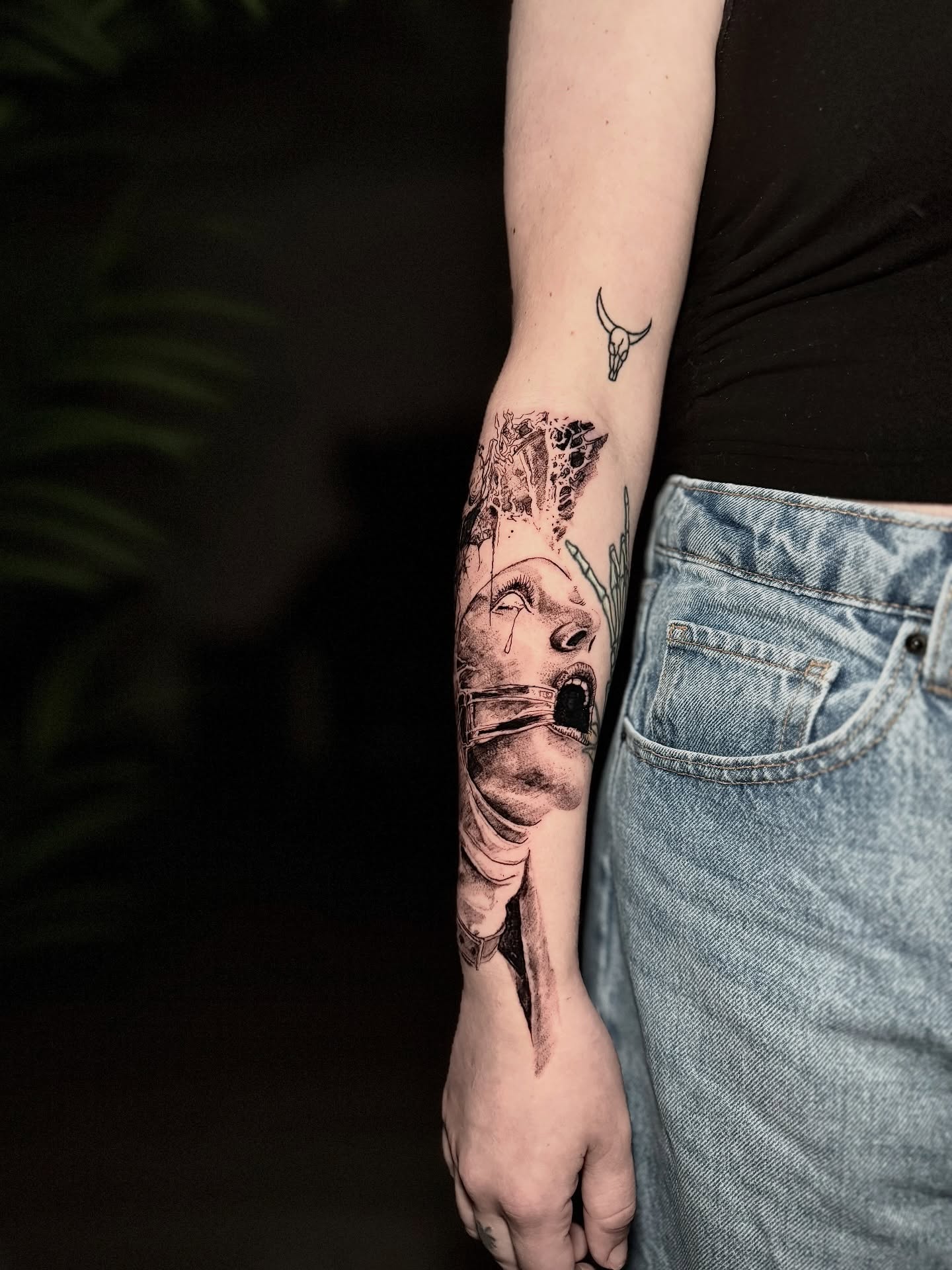 Abstract face dark realism tattoo on the forearm by Bwk Dark Art