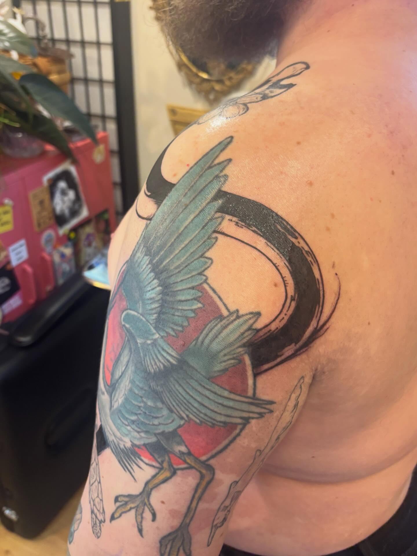 Bird and crescent moon American traditional tattoo on the shoulder by Zoe Brookes