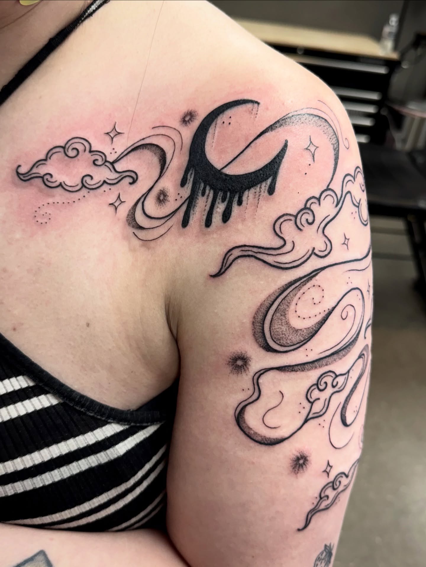 Moon and clouds dotwork tattoo on the shoulder by Samantha Jane
