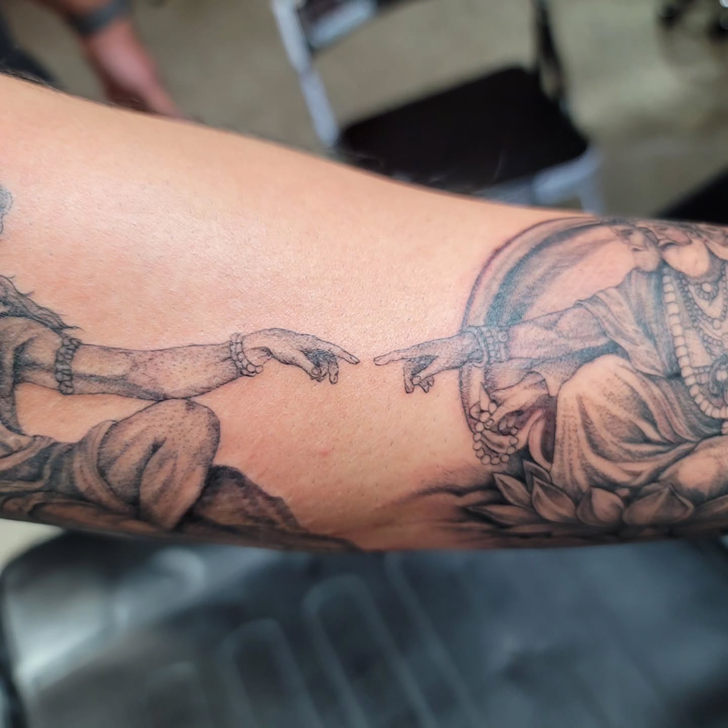 Touching hands realism tattoo on the forearm by Mary Lefeau
