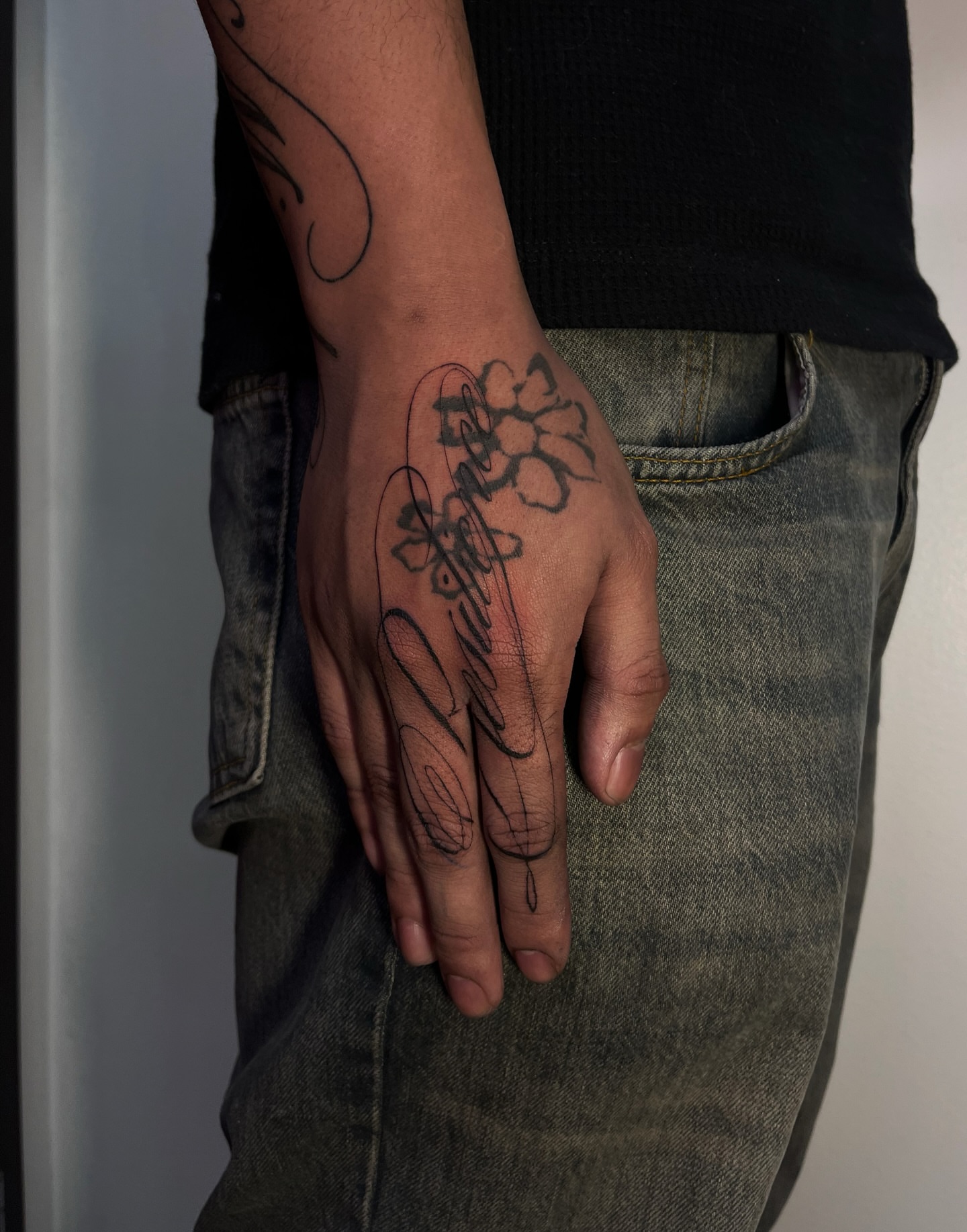 Cherry blossoms and cursive black and grey tattoo on the hand by MK