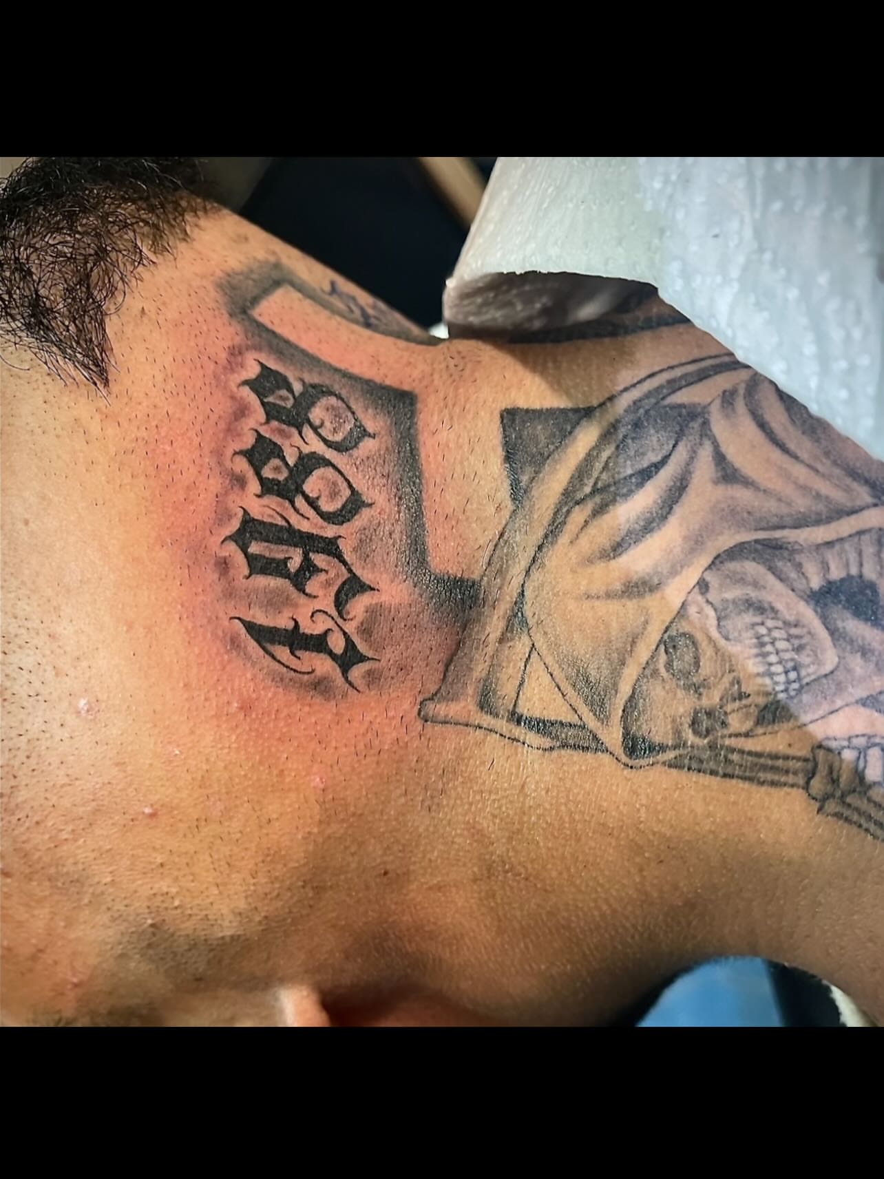 Skull and crossbones black and grey tattoo on the shoulder by Tu SanchoTattoos
