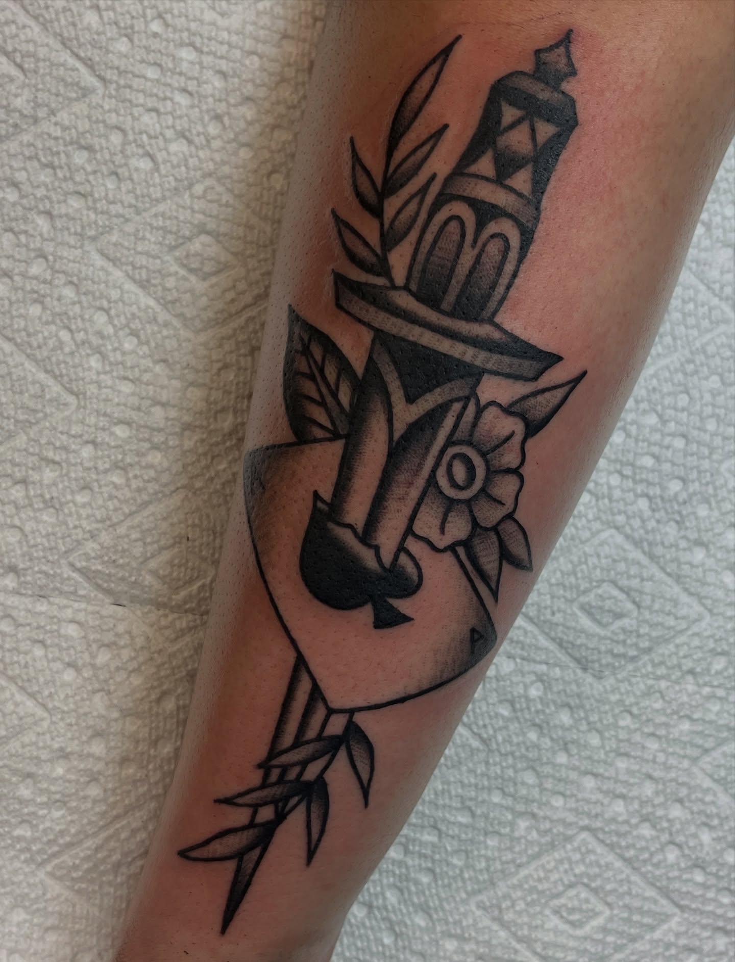 Knife and spade American traditional tattoo on the forearm by August B., Renton, Washington