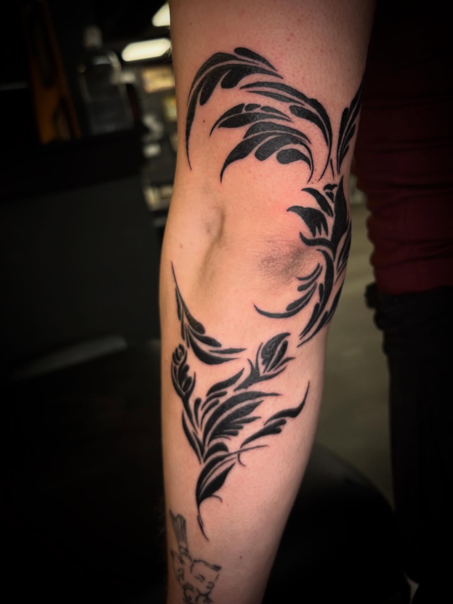 Feather tribal tattoo on the forearm by Brett Ferguson