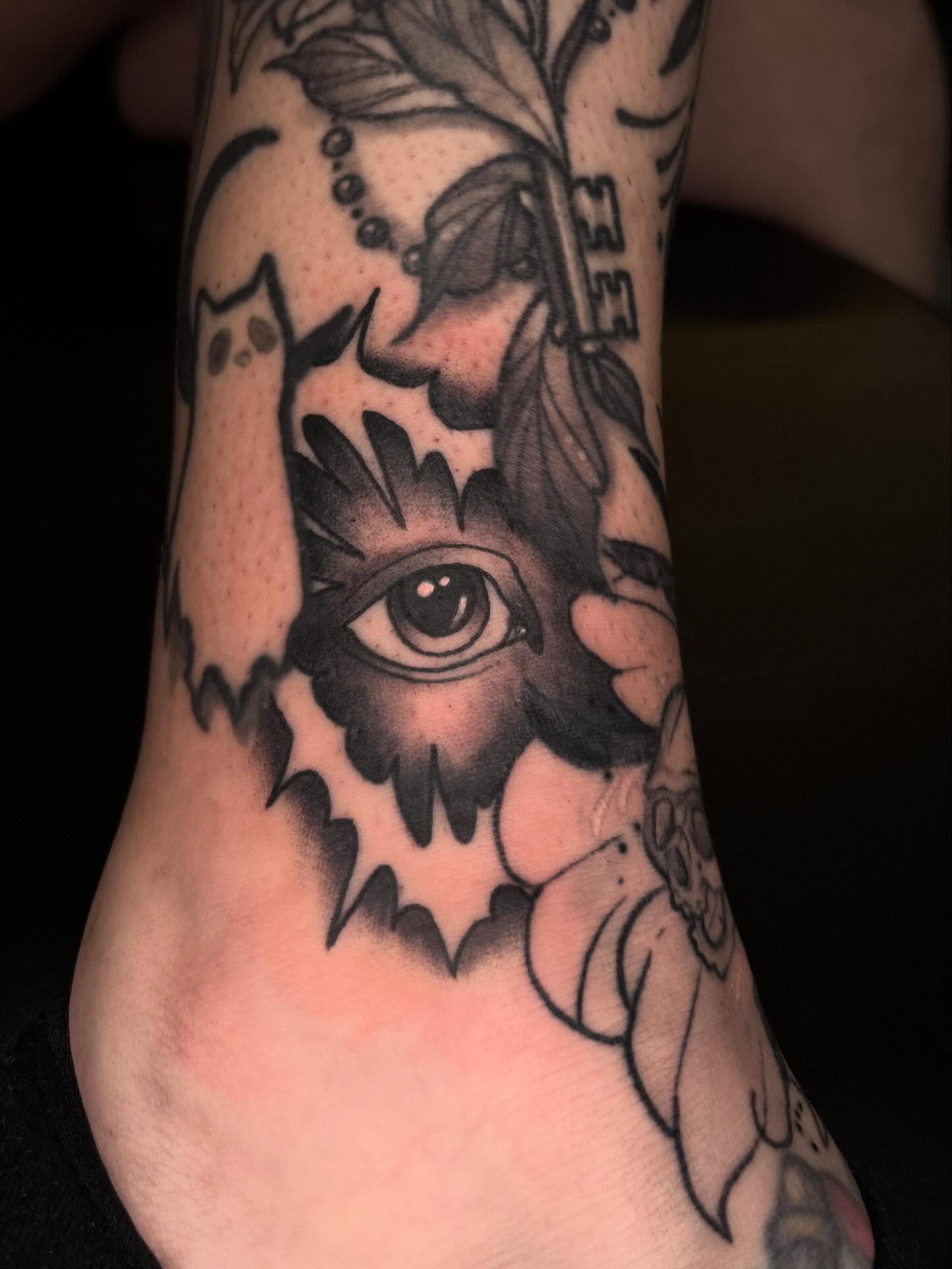Owl with eye black and grey tattoo on the foot by Brett Ferguson