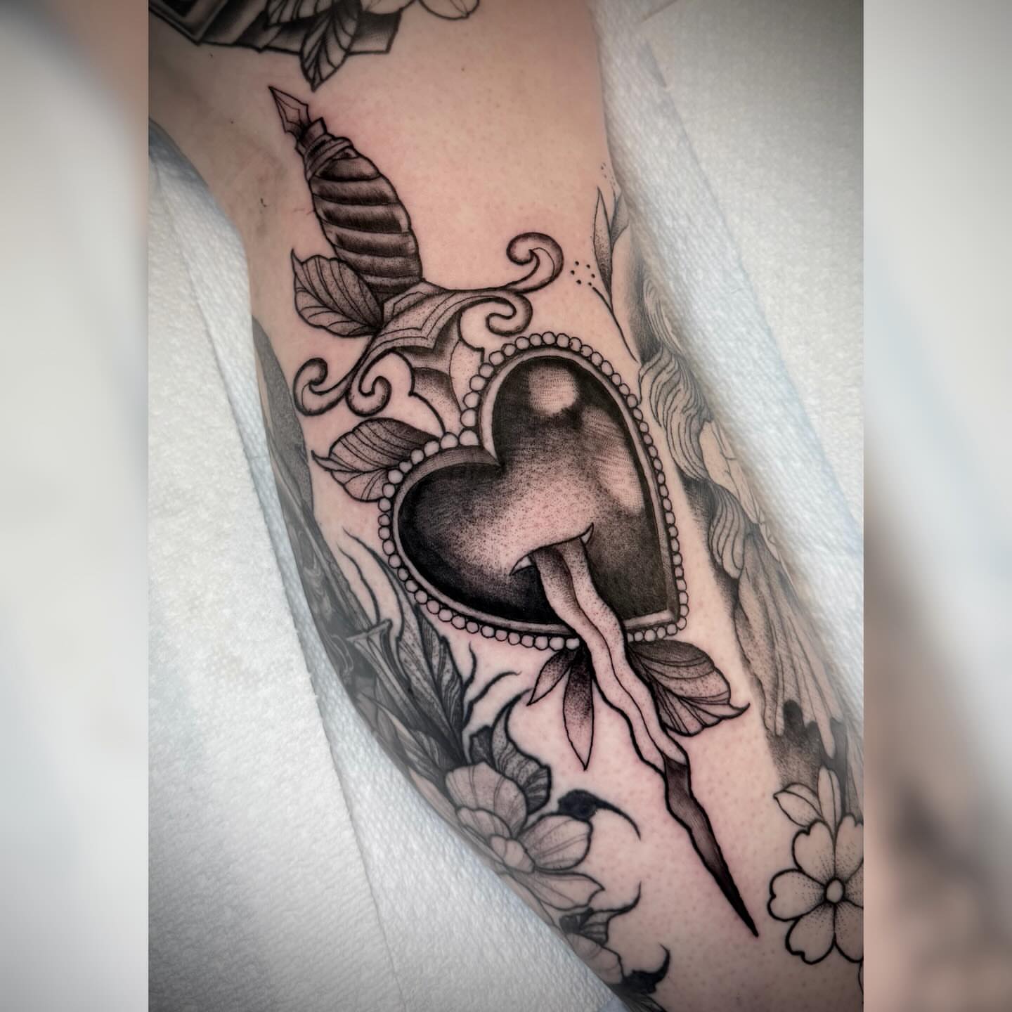 Heart with dripping blood realism tattoo on the forearm by Alyssa Deeghan