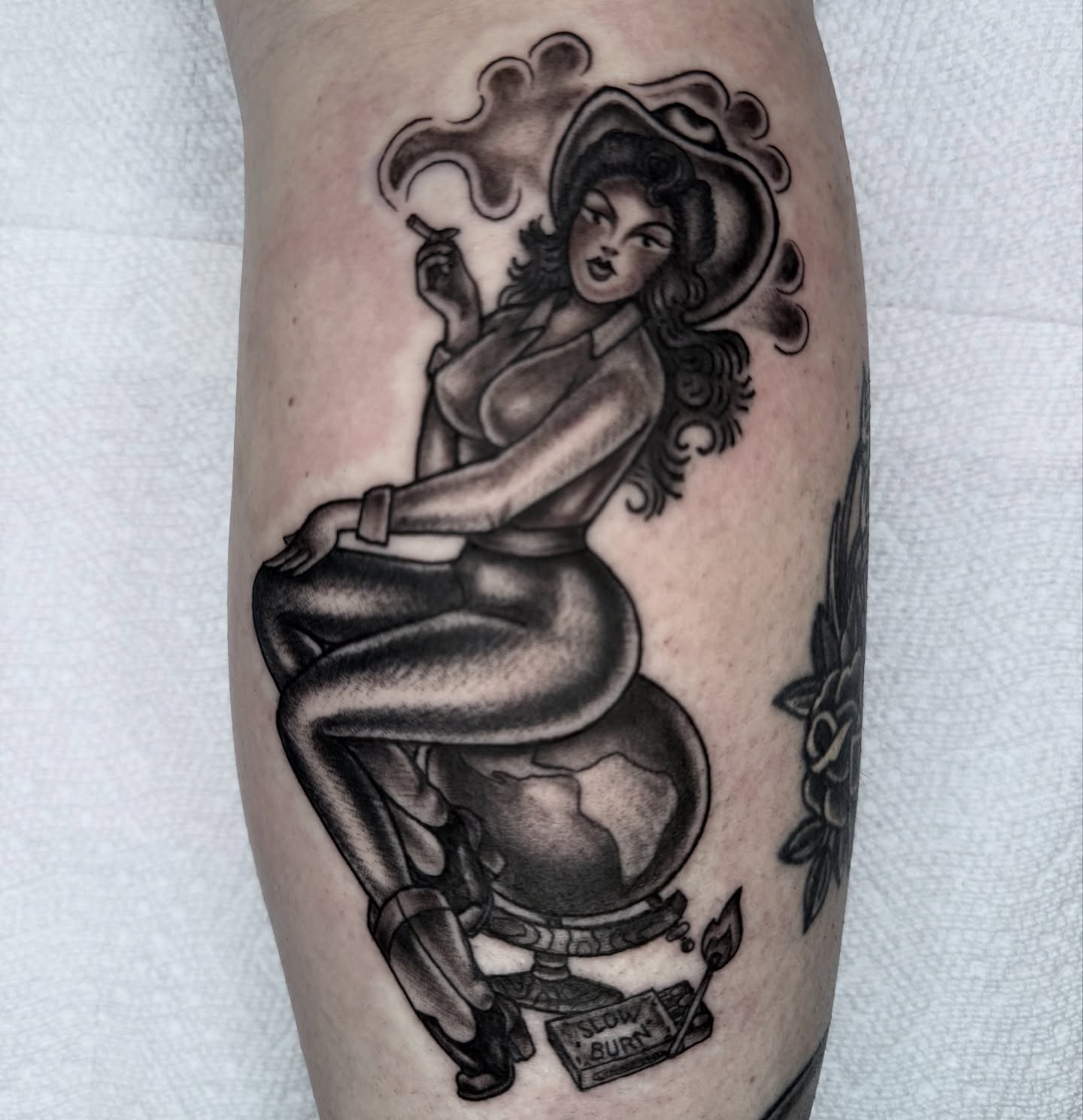 Pin-up girl American traditional tattoo on the forearm by Lisa Del Toro