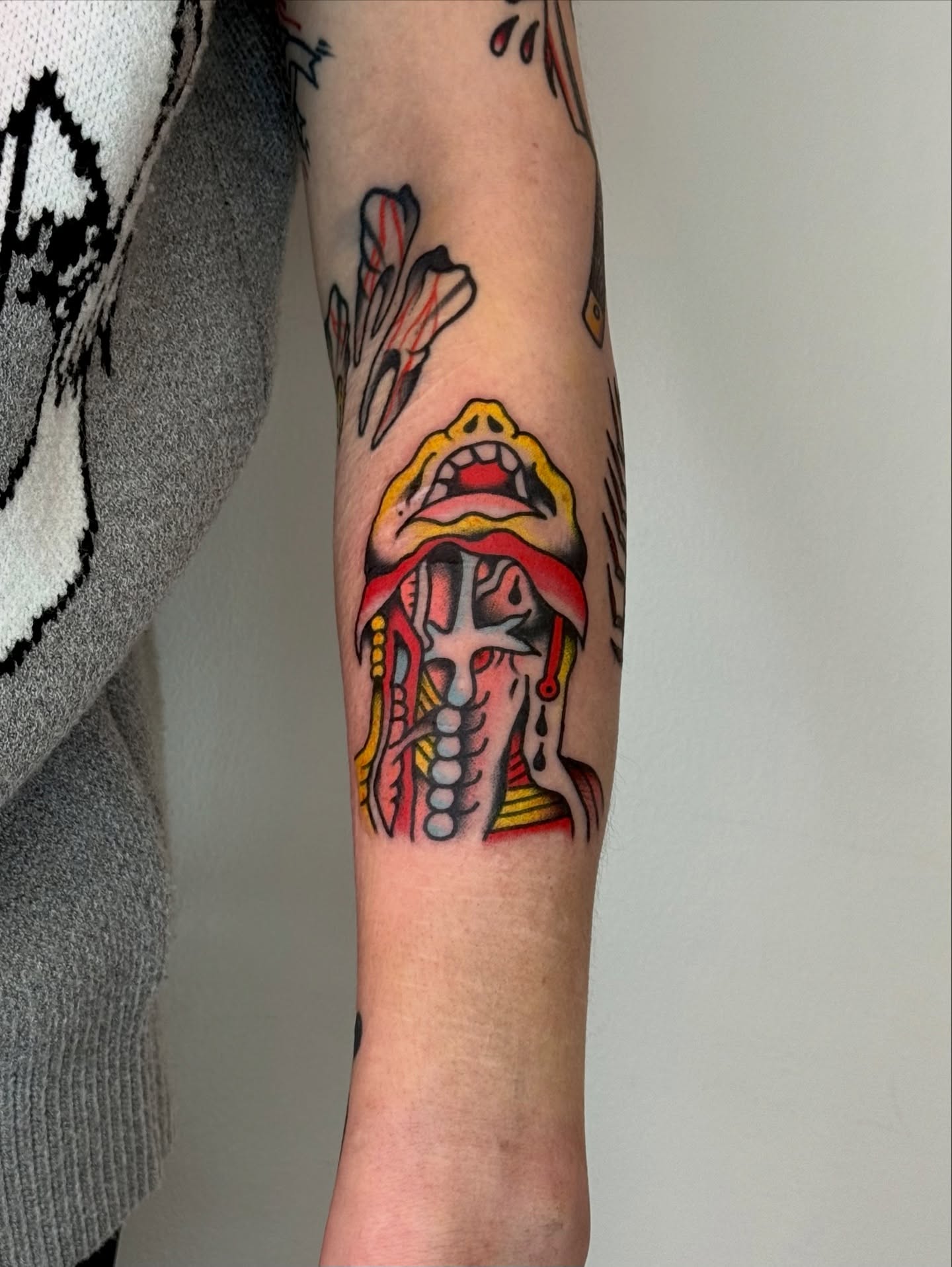Open mouth American traditional tattoo on the forearm by Roman
