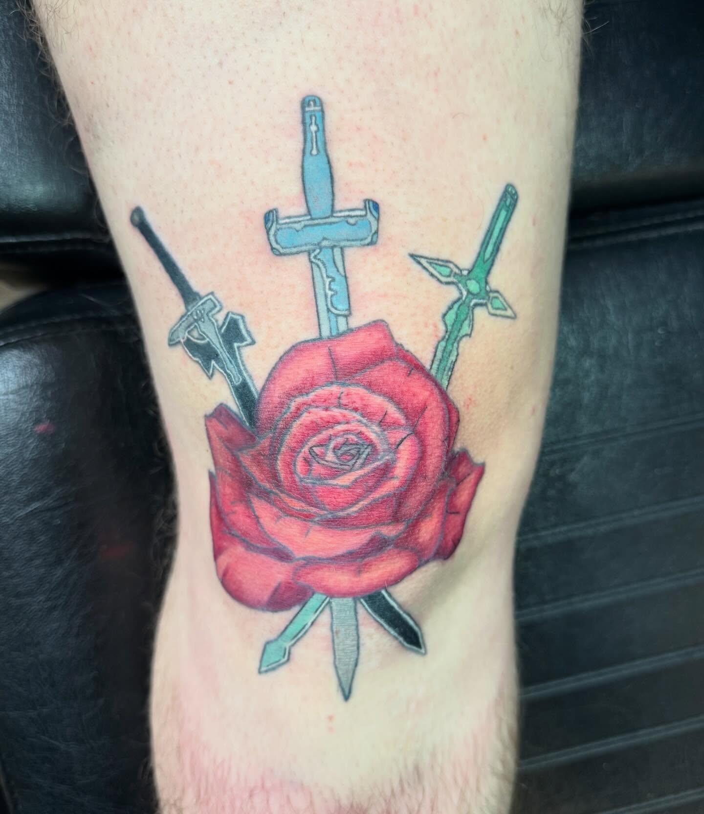 Red rose with swords American traditional tattoo on the thigh by Elena