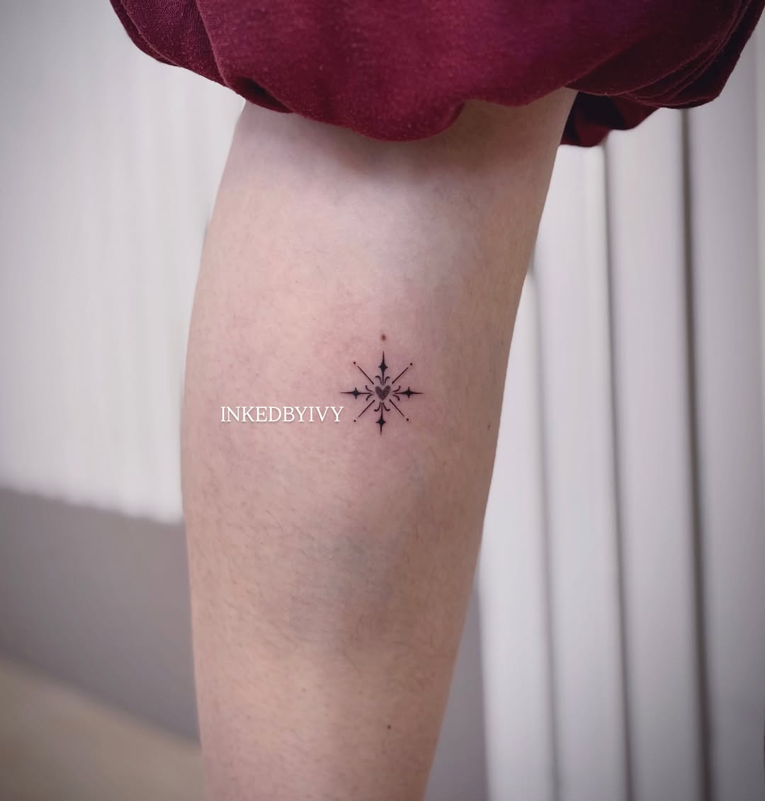 Compass rose with heart ornamental tattoo on the forearm by IVY