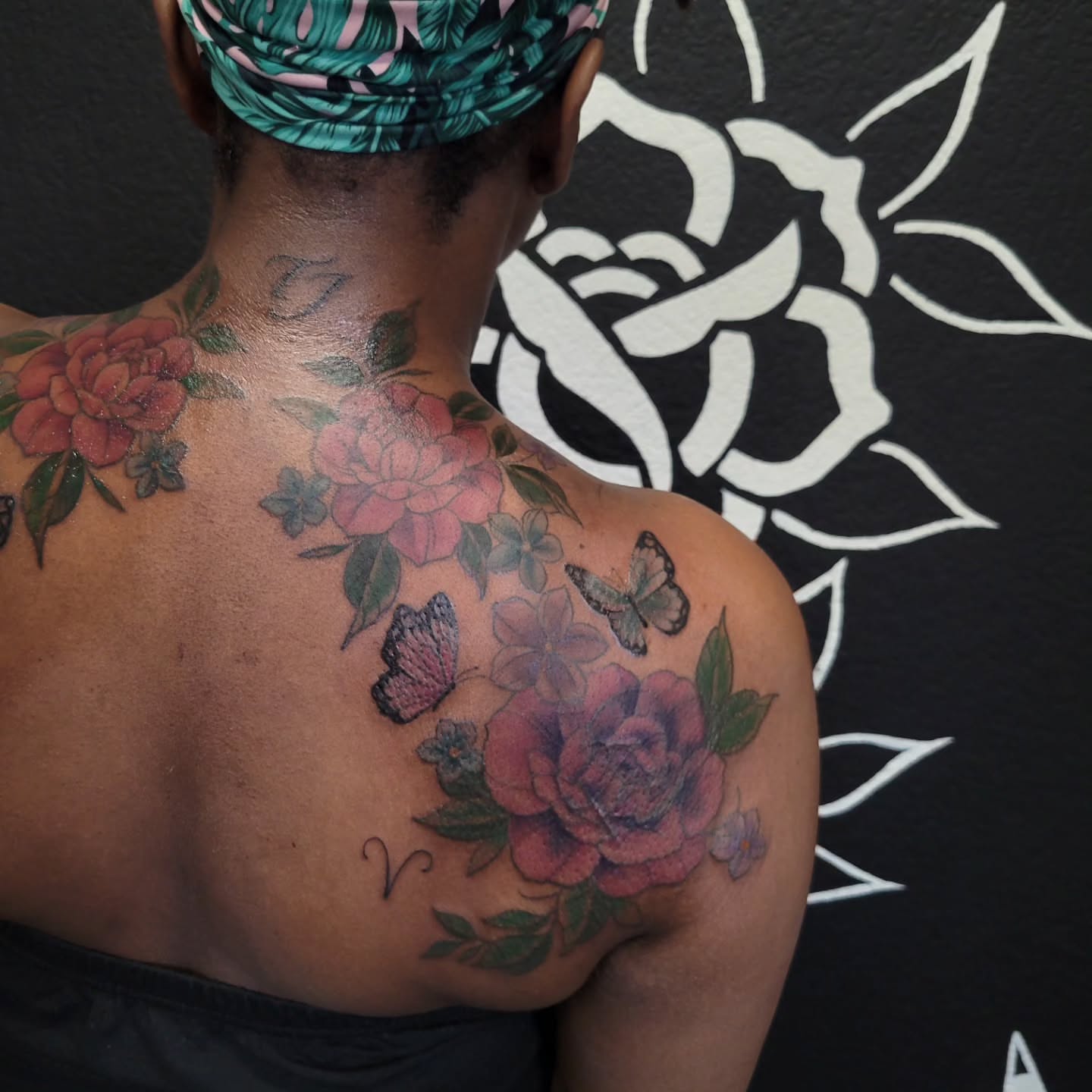 Flowers and butterflies American traditional tattoo on the back by Marina Cobb