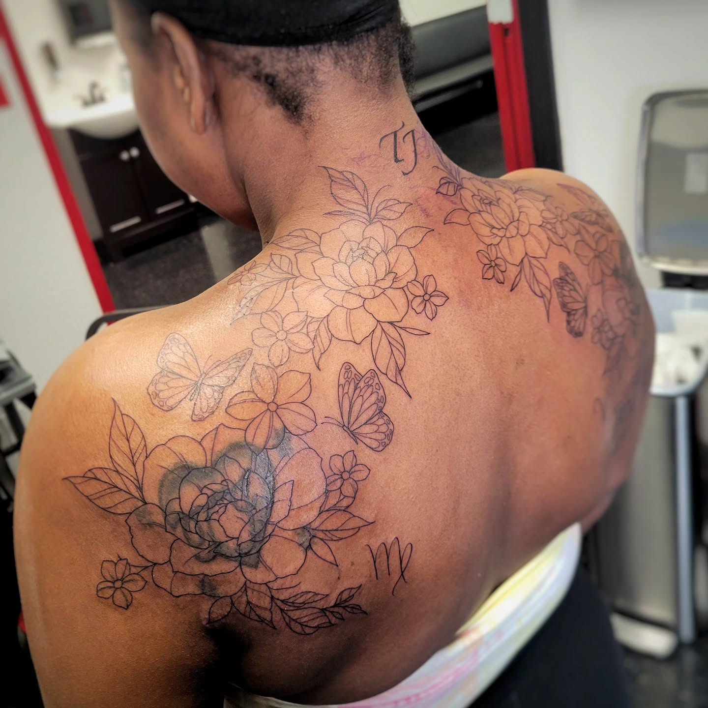 Floral bouquet black and grey tattoo on the back by Marina Cobb