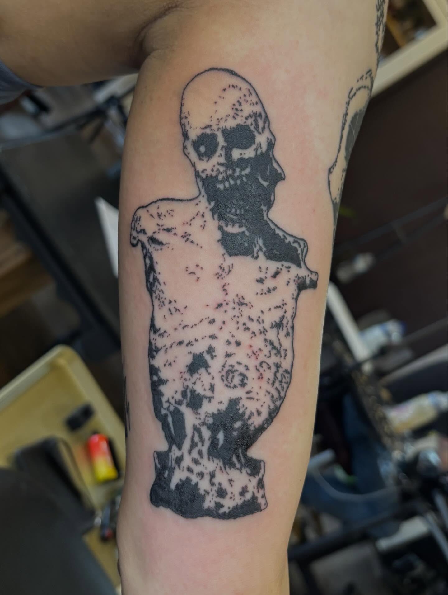 Skull black and grey tattoo on the forearm by Turner