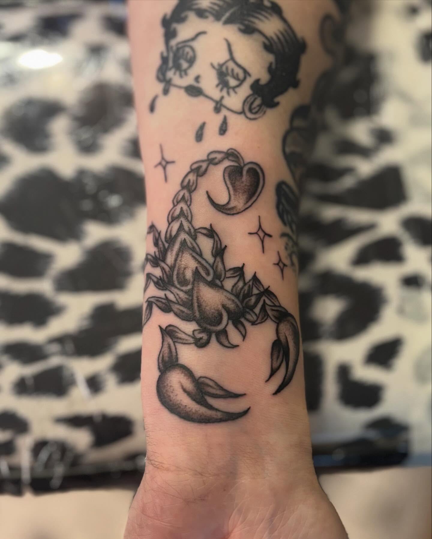Scorpion and Betty Boop dotwork tattoo on the forearm by Tia Cave