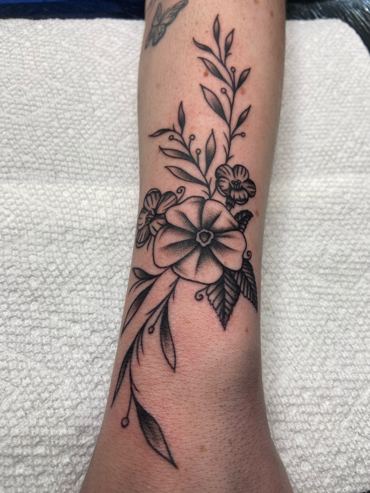 Floral arrangement black and grey tattoo on the forearm by R y a n S m i t h
