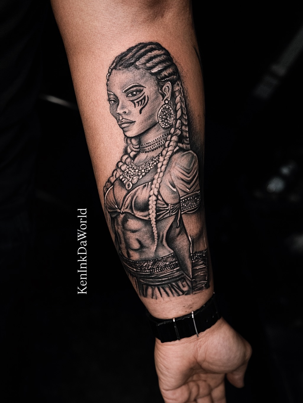 Woman with braids realism tattoo on the forearm by Ken West