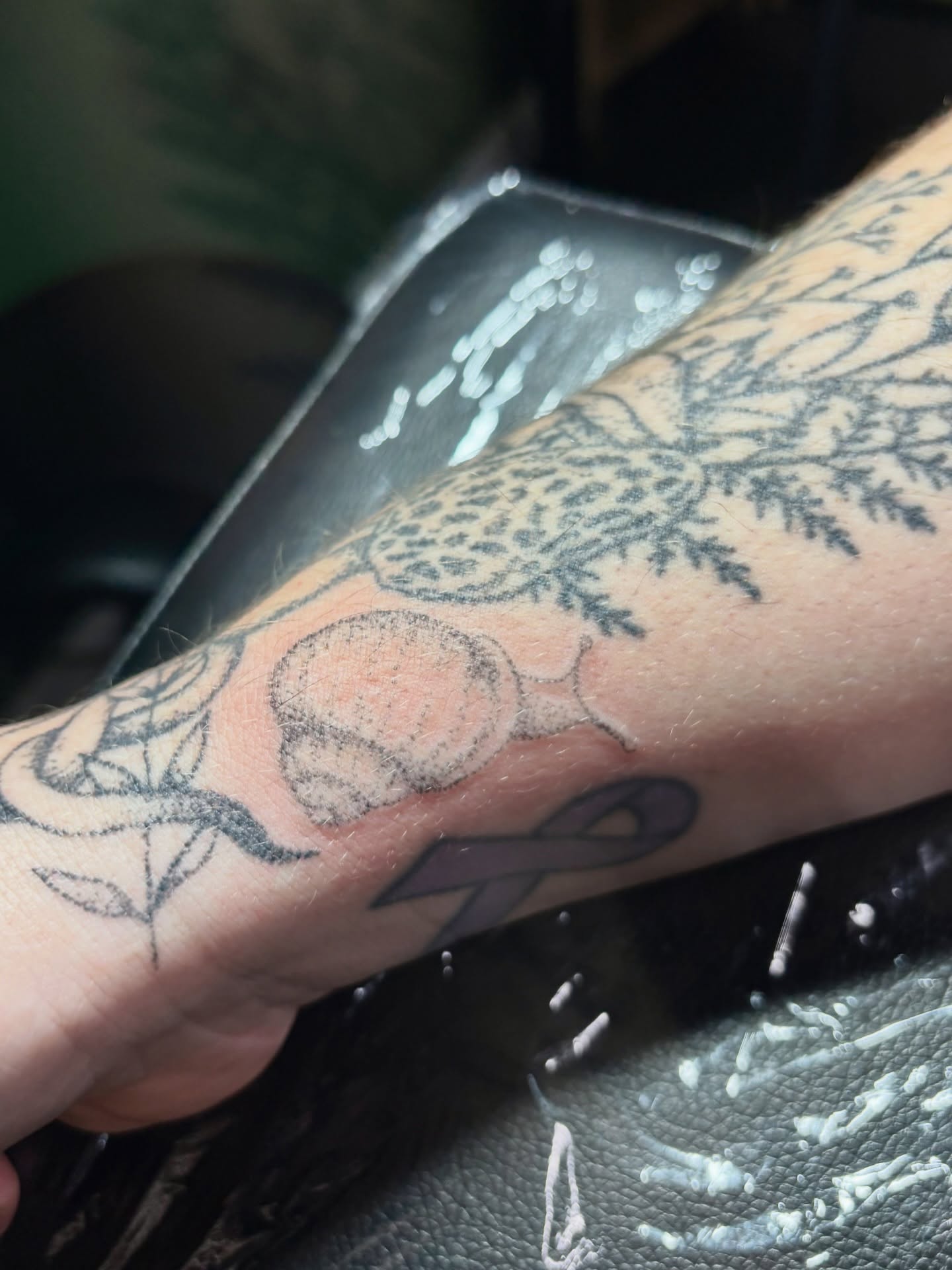 Peach and leaves black and grey tattoo on the forearm by Ashley, Elk Horn, Iowa