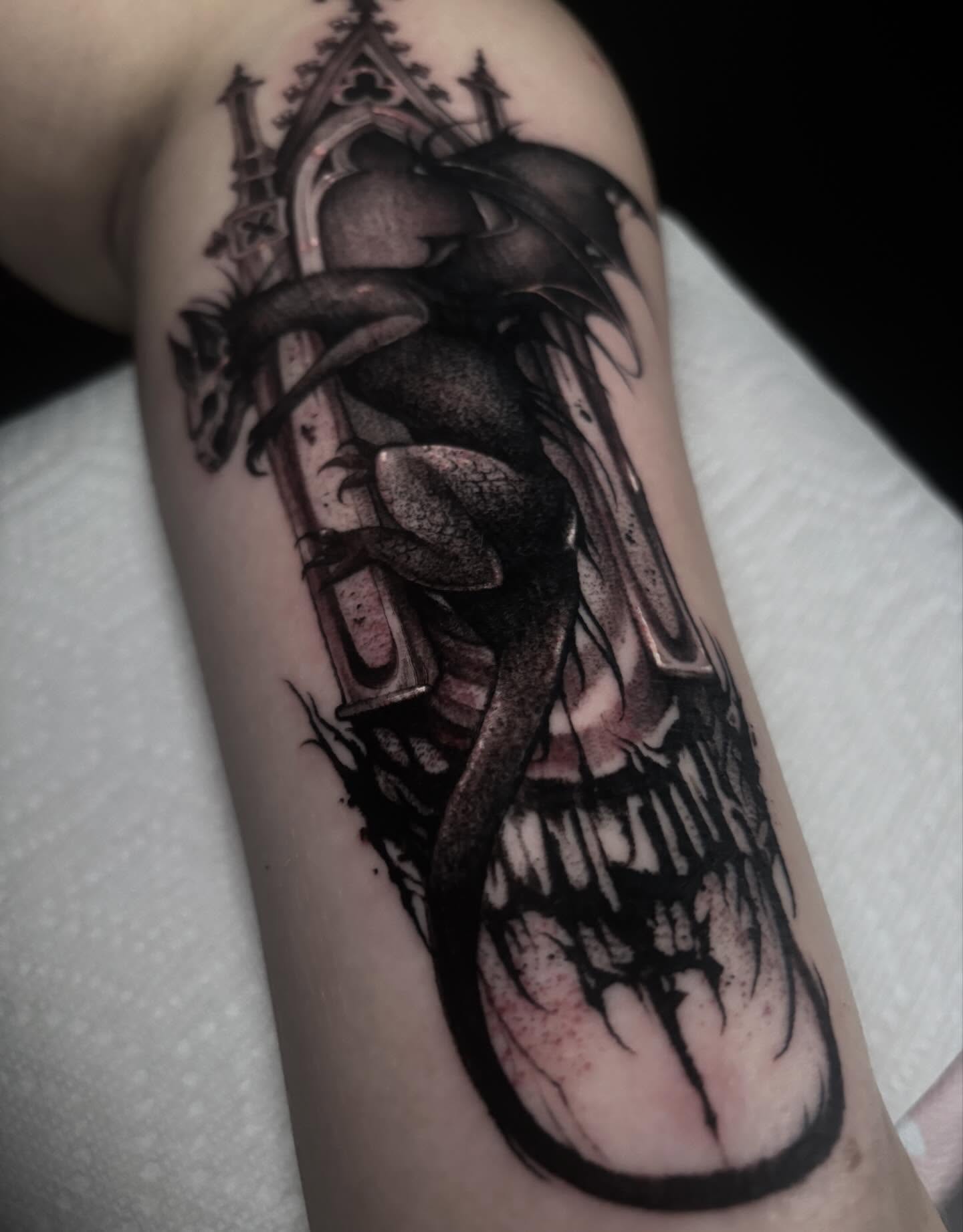 Skull with wings dark realism tattoo on the forearm by Alle