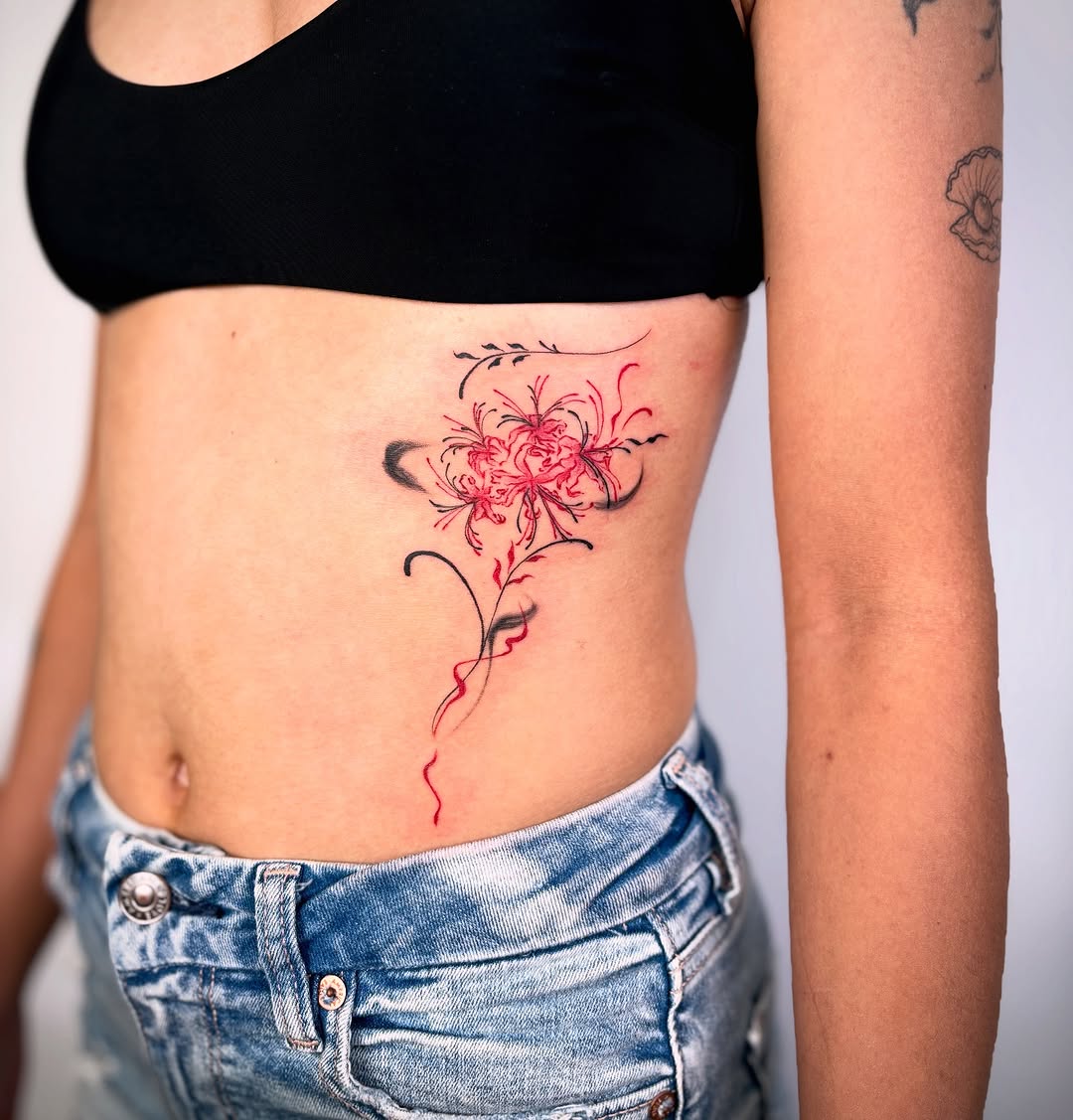 Spider lily watercolor tattoo on the ribs by *:・kelly✧*:・゚