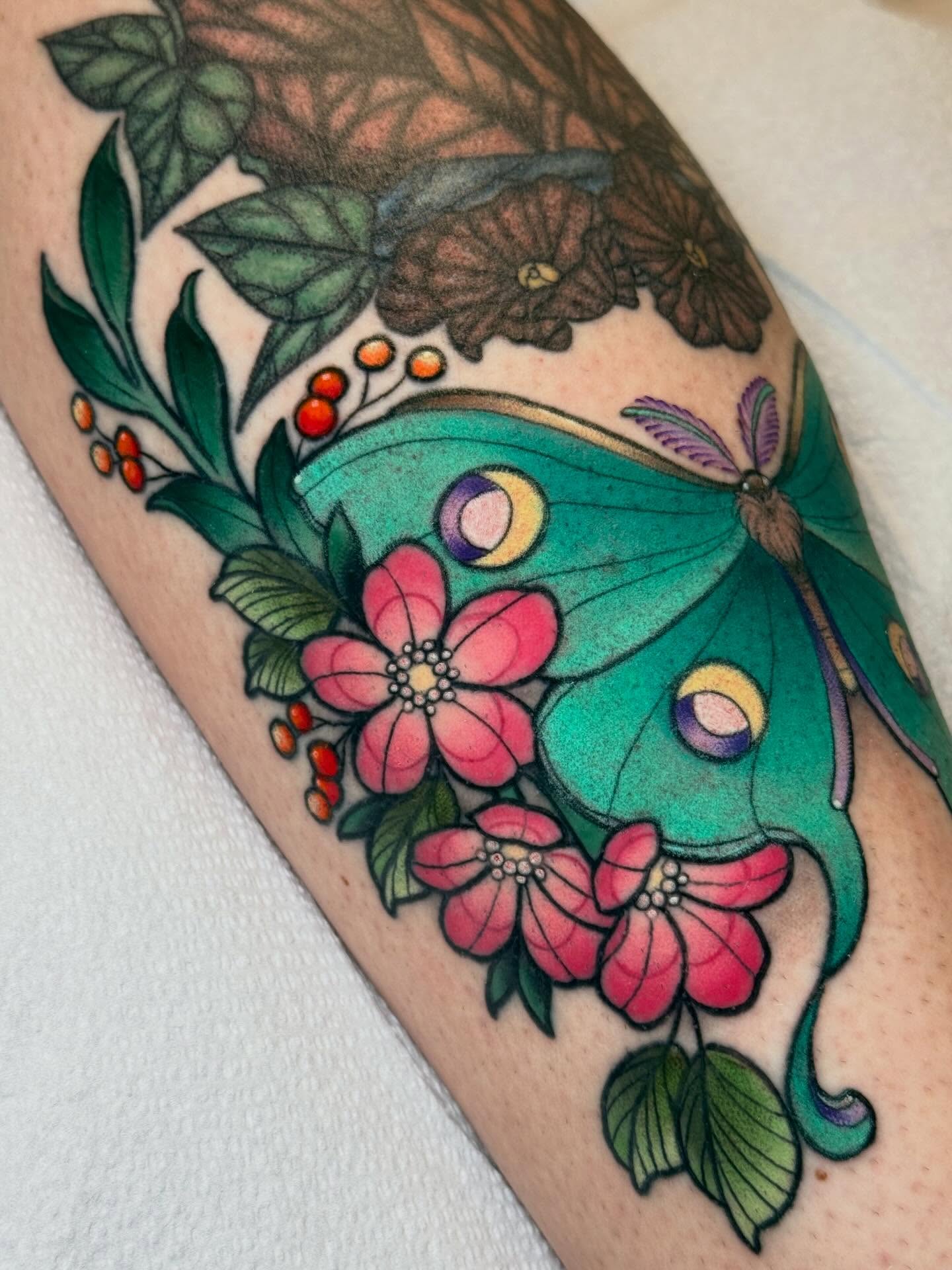 Butterfly and flowers new school tattoo on the forearm by Kayla Warren