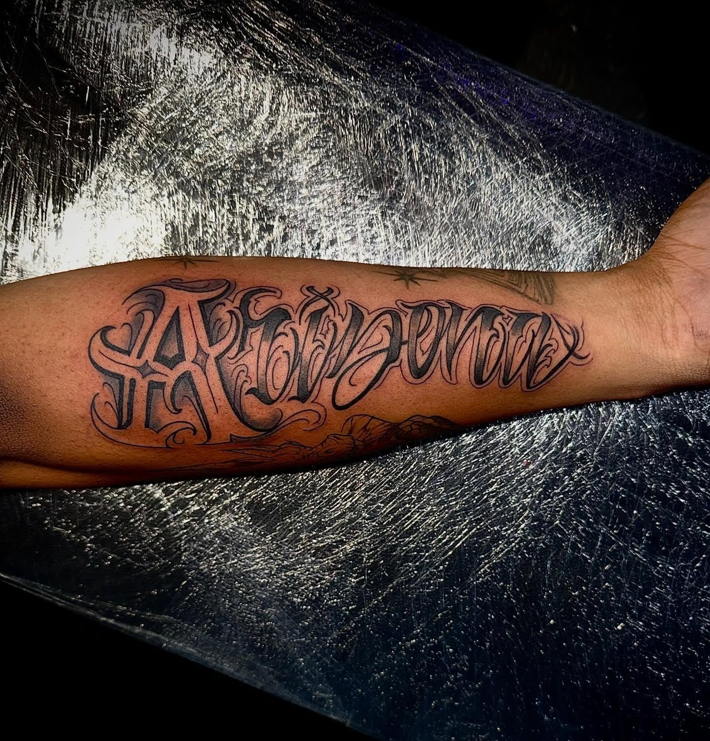 Script lettering lettering script tattoo on the forearm by Clifford Jordan