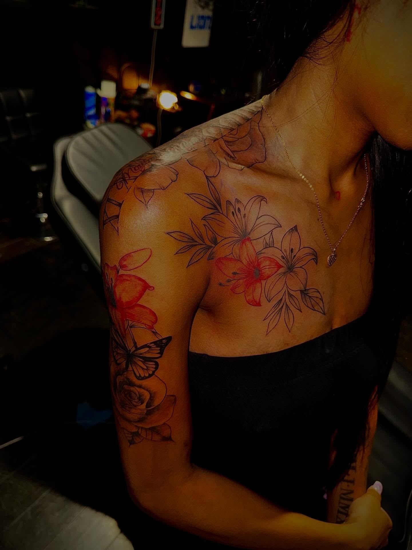 Floral arrangement neo-traditional tattoo on the shoulder by Clifford Jordan