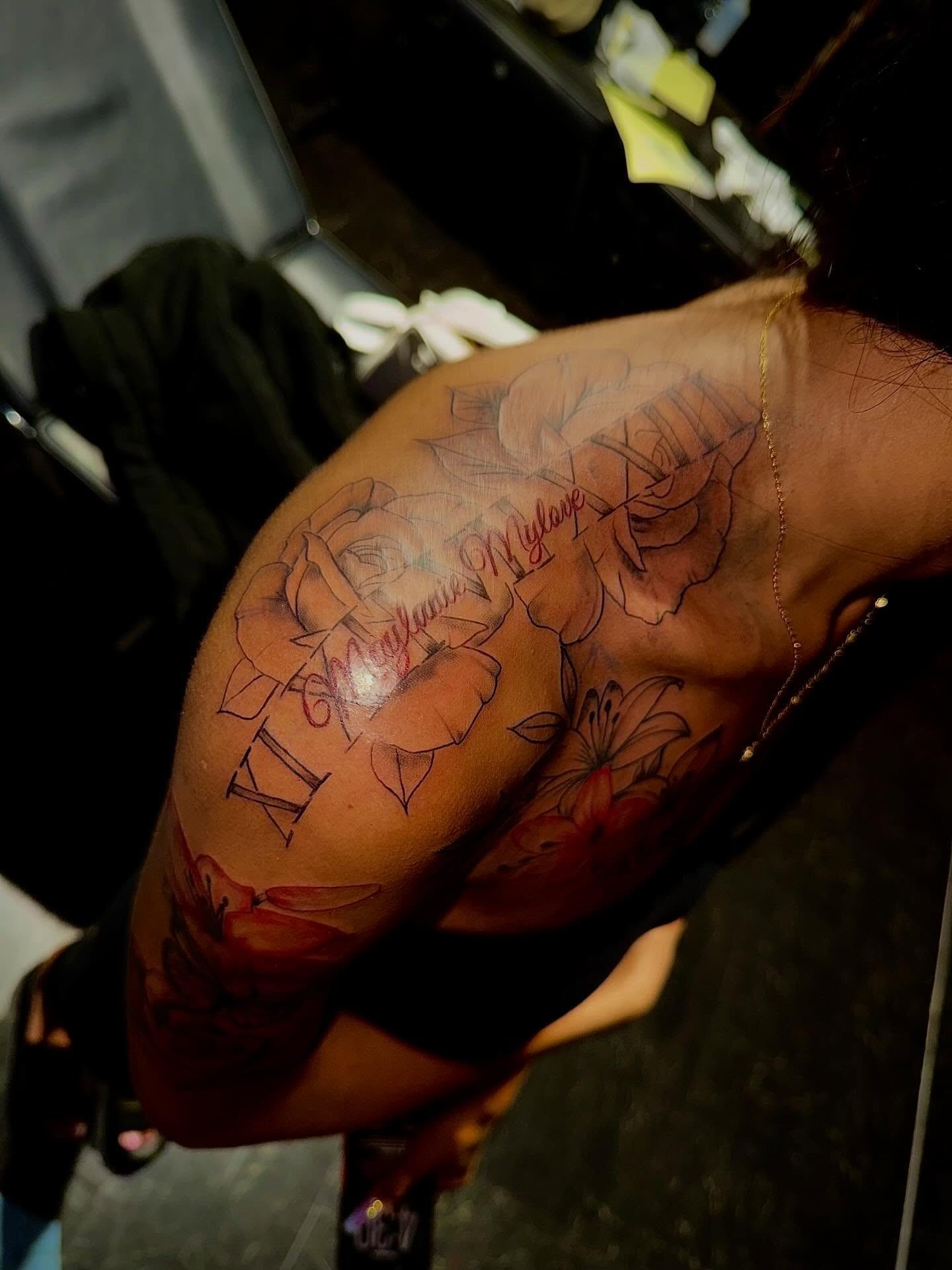 Floral arrangement black and grey tattoo on the shoulder by Clifford Jordan