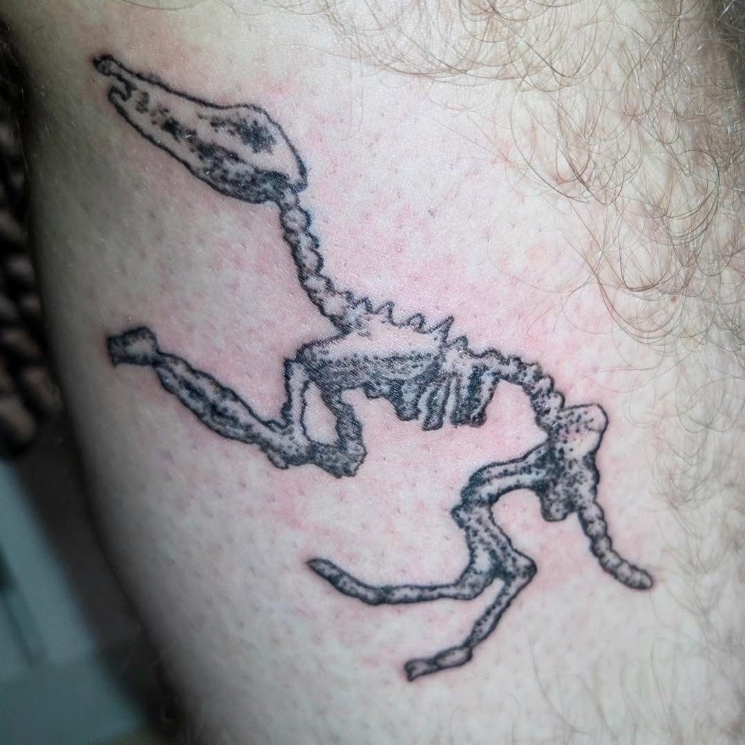 Dinosaur skeleton blackwork tattoo on the forearm by π«