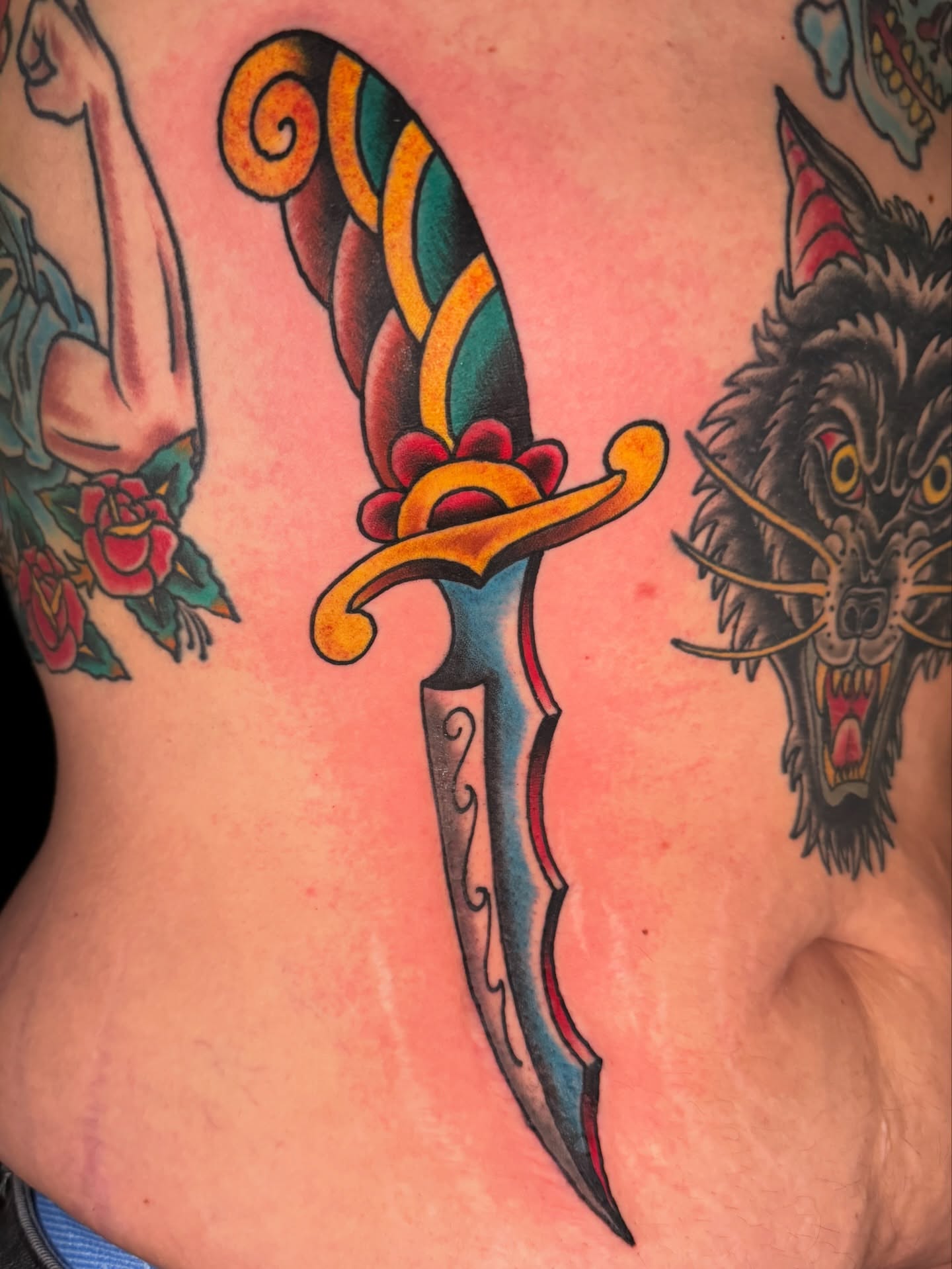 Saber American traditional tattoo on the torso by Cary Aldridge