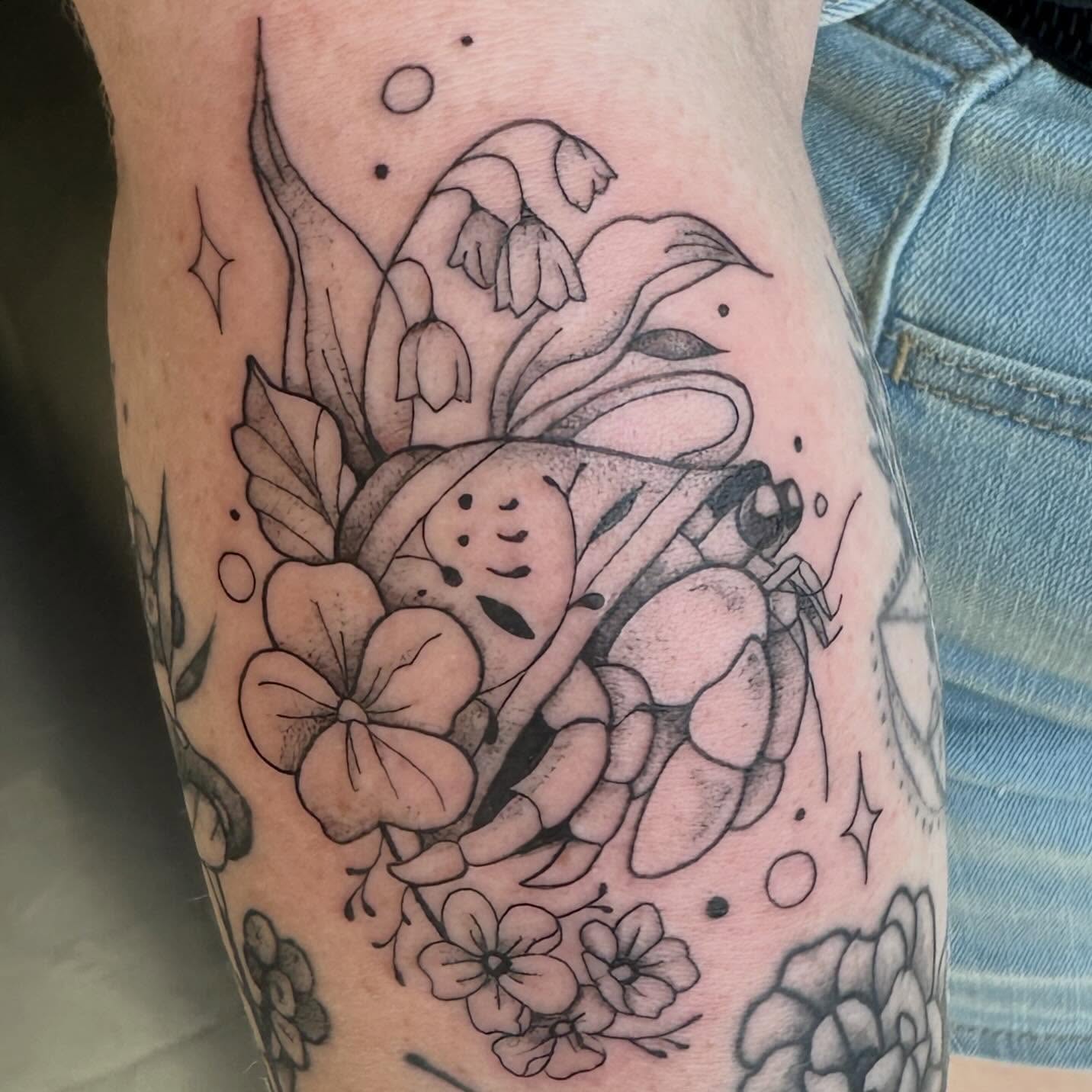 Frog and flowers black and grey tattoo on the forearm by Sam, Mount Laurel, New Jersey