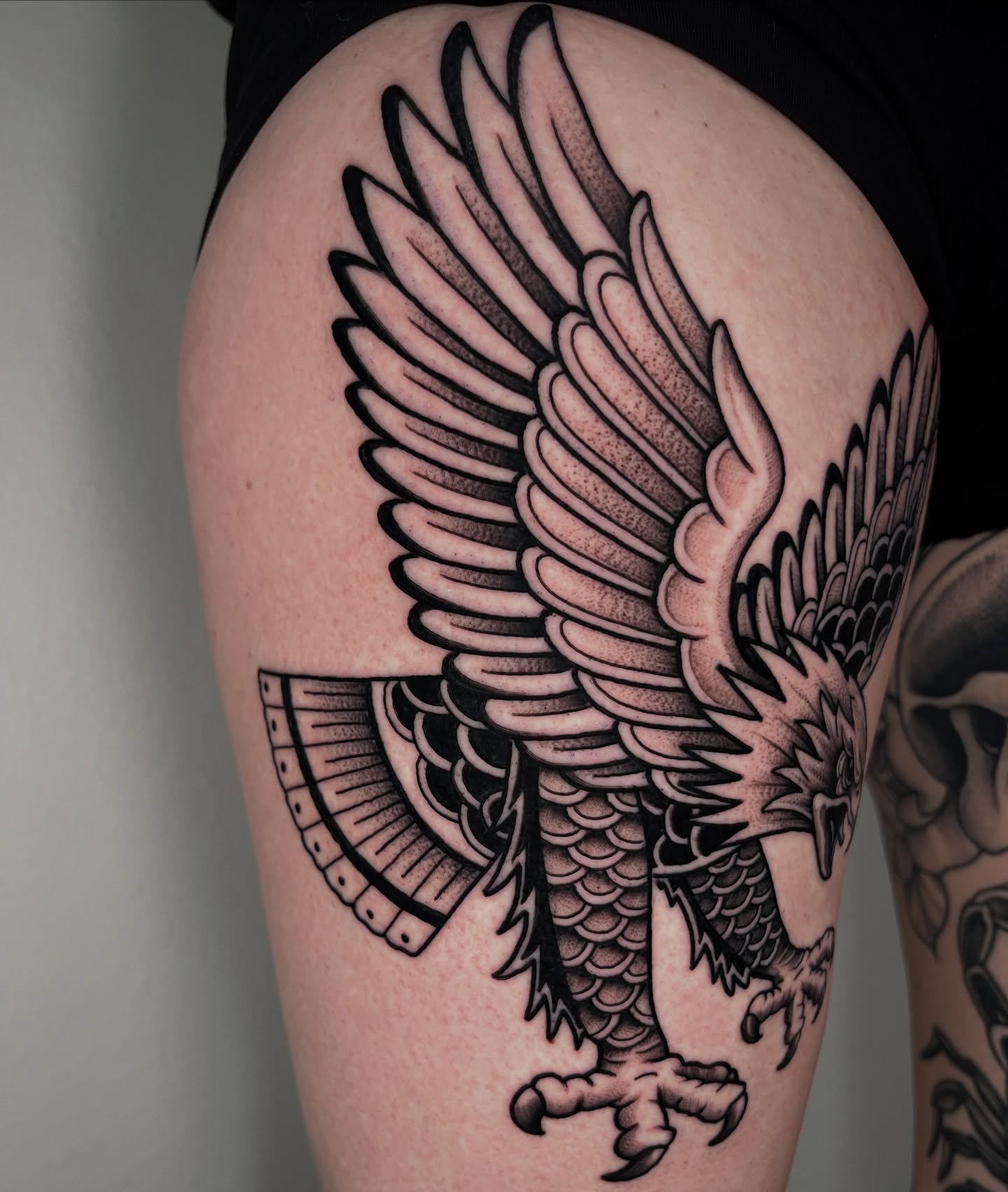 Eagle black and grey tattoo on the thigh by Jordan Hunt