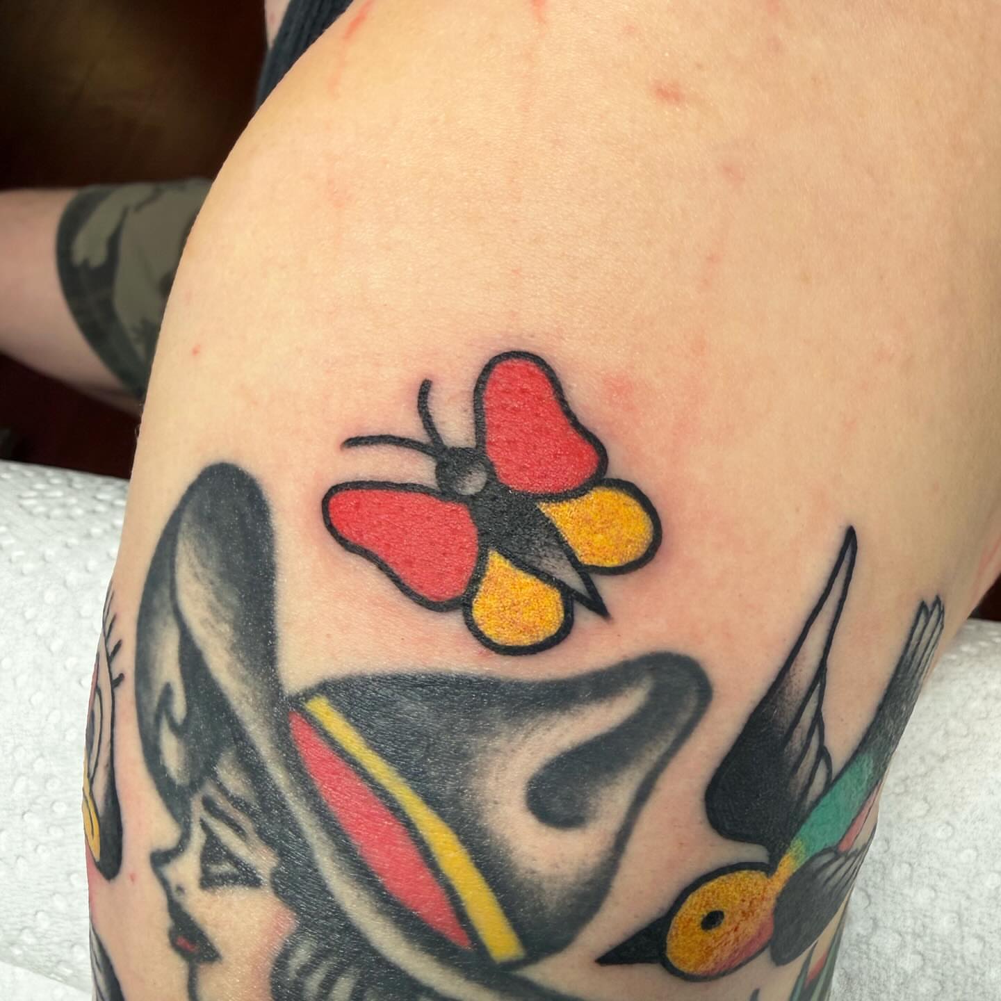 Butterfly American traditional tattoo on the upper arm by ༺tessa༻