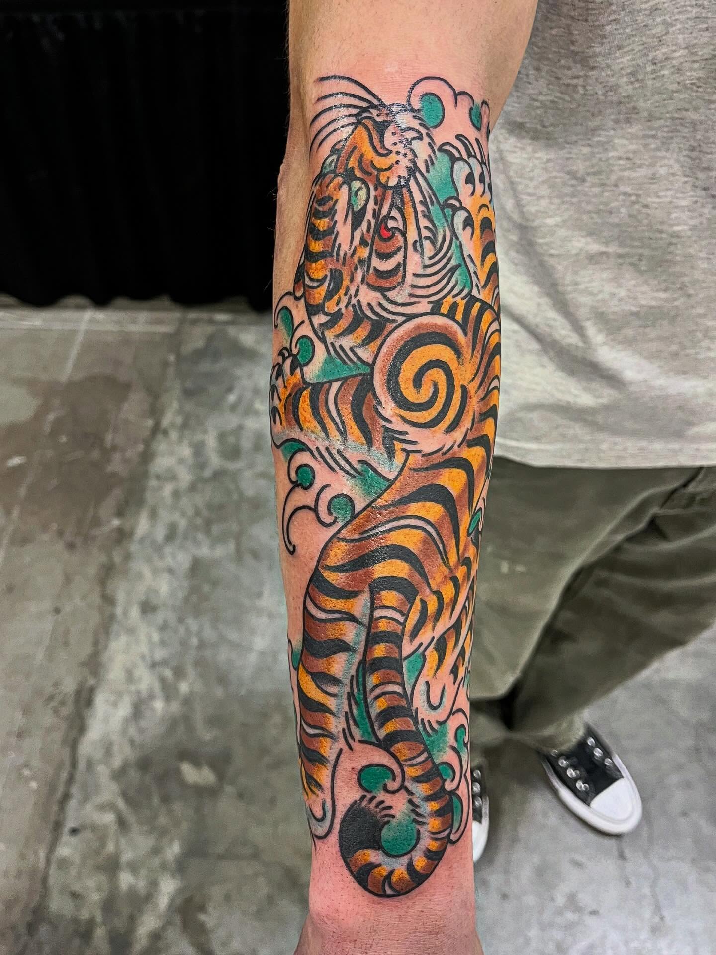 Tiger American traditional tattoo on the forearm by Graham Niles