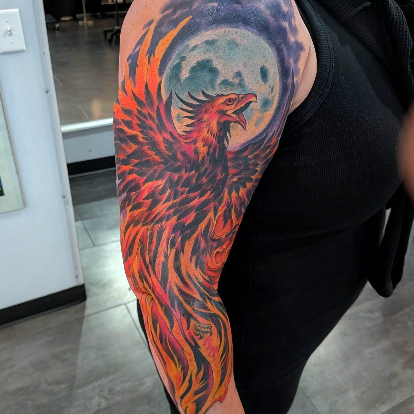 Flaming phoenix new school tattoo on the forearm by Nic Skrade, Minneapolis, Minnesota